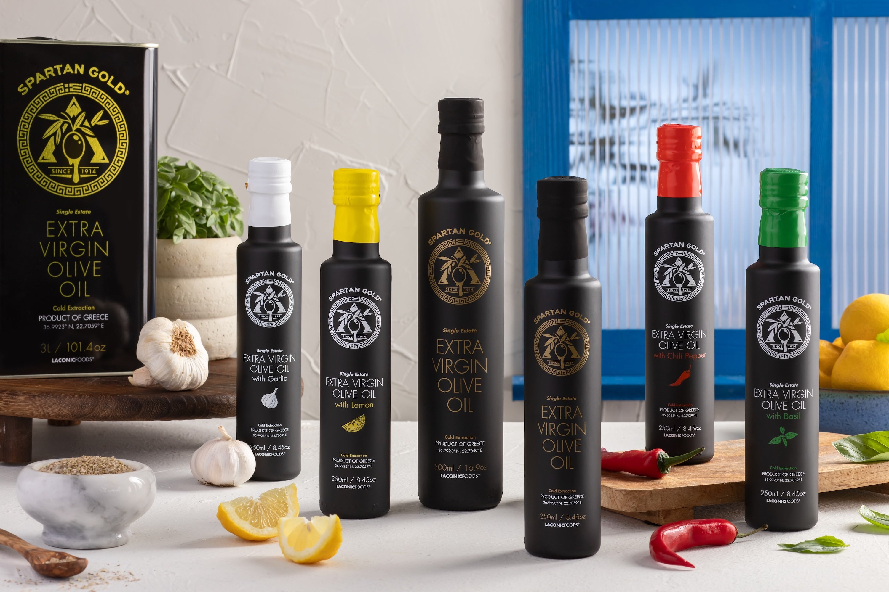 Award-winning Greek extra virgin olive oils by Laconic Foods, featuring garlic, lemon, chili, basil, and unflavored single estate EVOO in matte black bottles.
