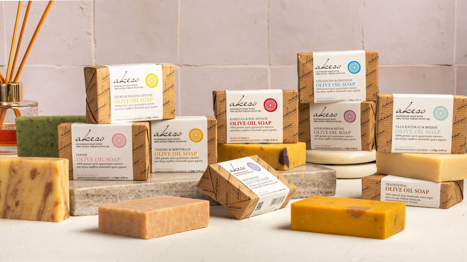 Laconic Foods handmade Greek olive oil soap collection with assorted soap bars and wrapped Akeso soap boxes on a bathroom-style display.