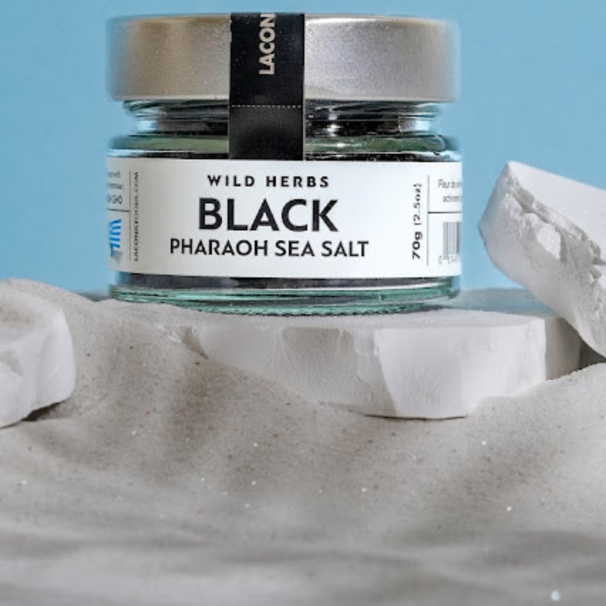 Greek Black Pharaoh Sea Salt 70g jar by Laconic Foods – gourmet seasoning photographed in sandscape