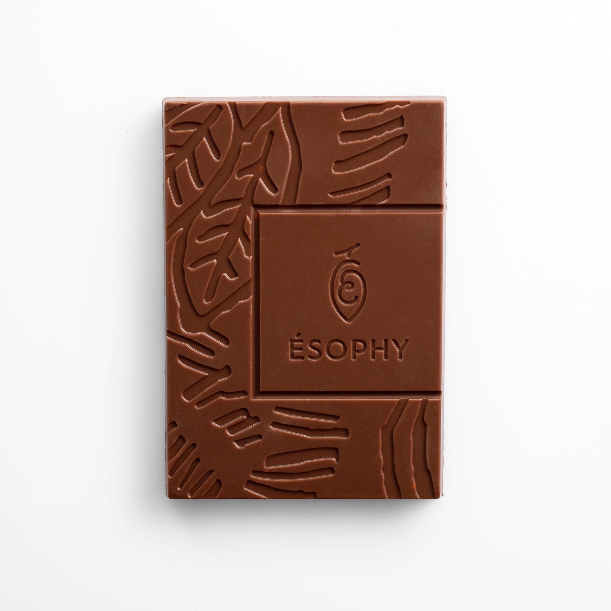 Unwrapped ÉSOPHY milk chocolate bar with embossed design and Greek hazelnut croquant
