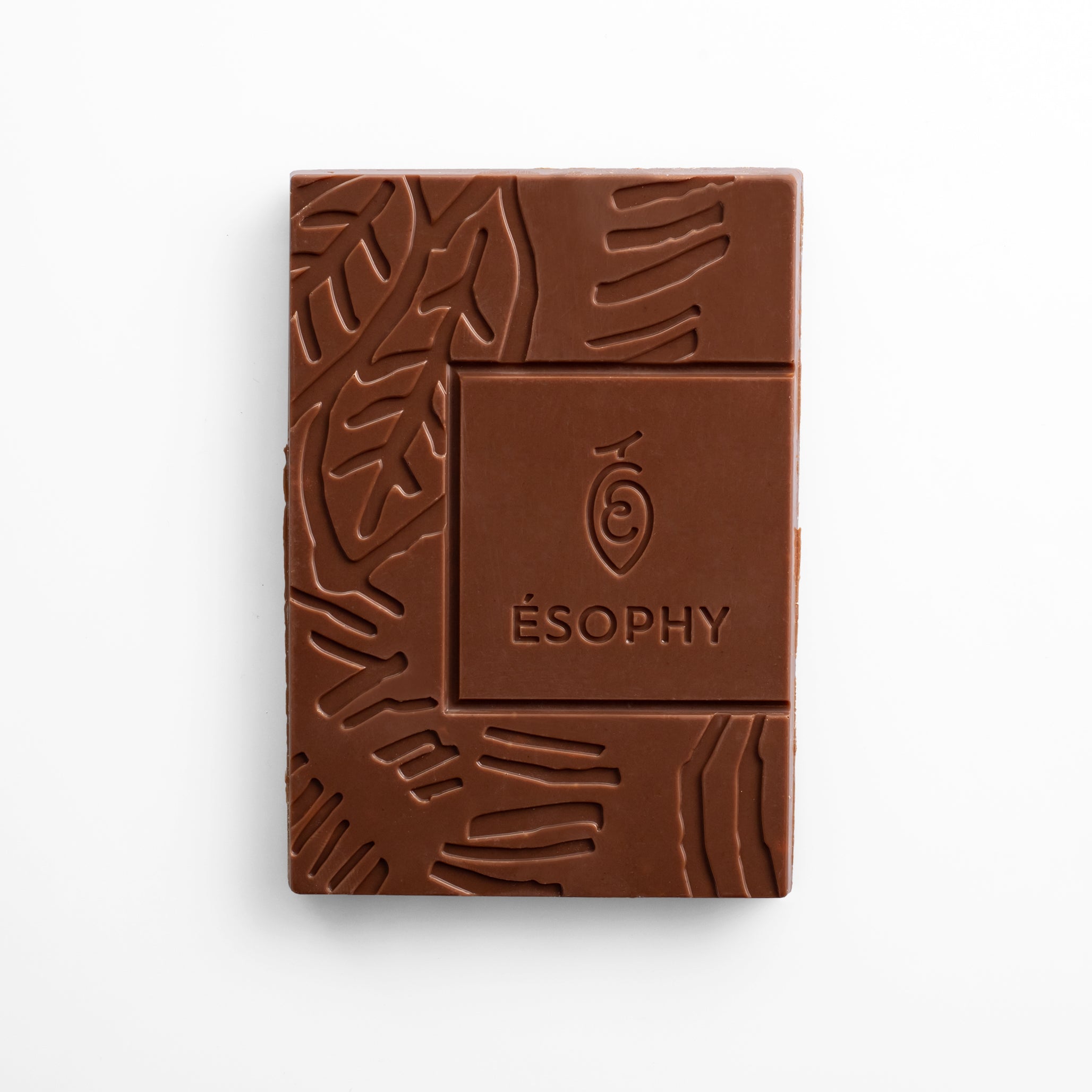 Unwrapped ÉSOPHY milk chocolate bar with embossed design and Mediterranean citrus flavor