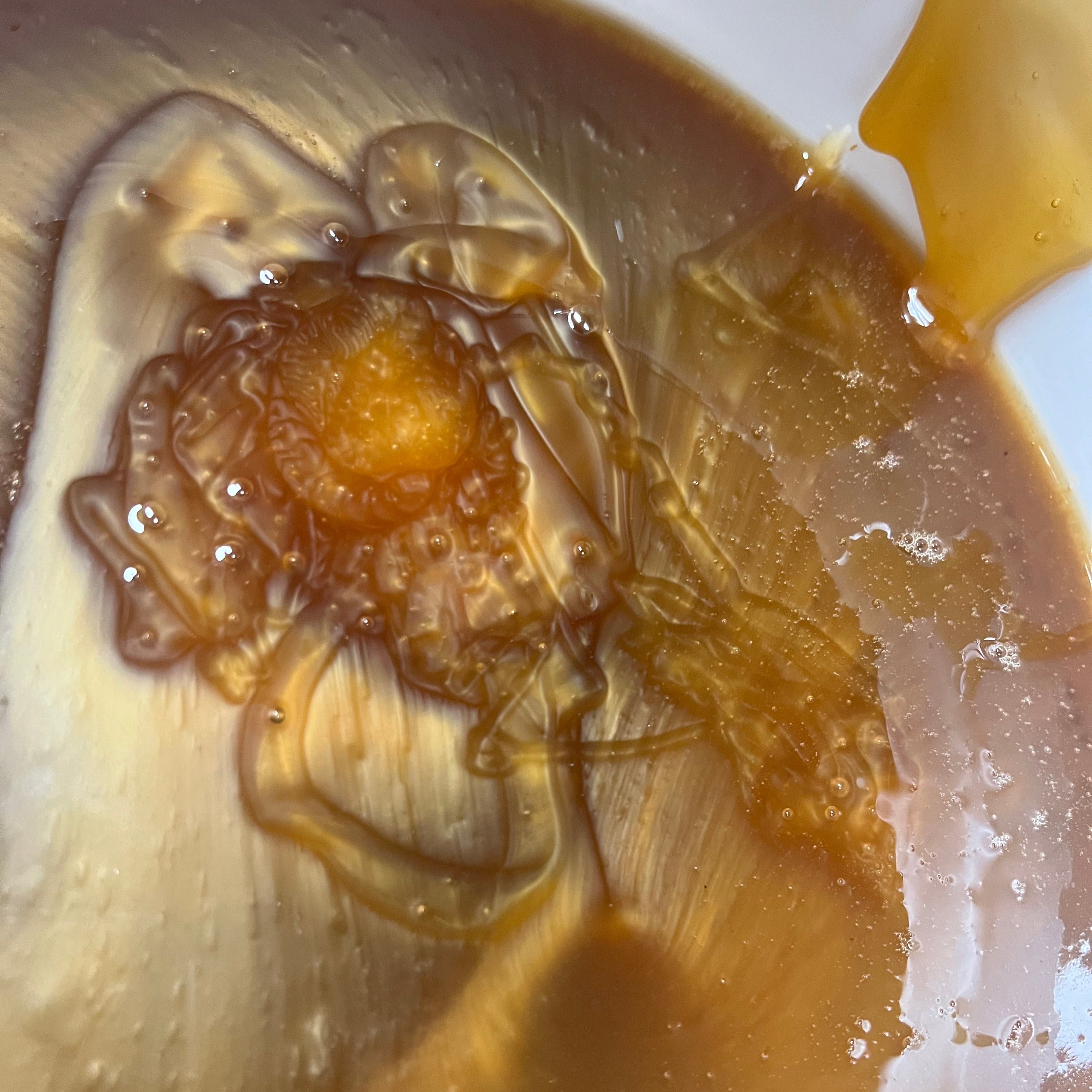 Close-up of swirled Vanilla Fir Honey showing thick, creamy texture and natural streaks