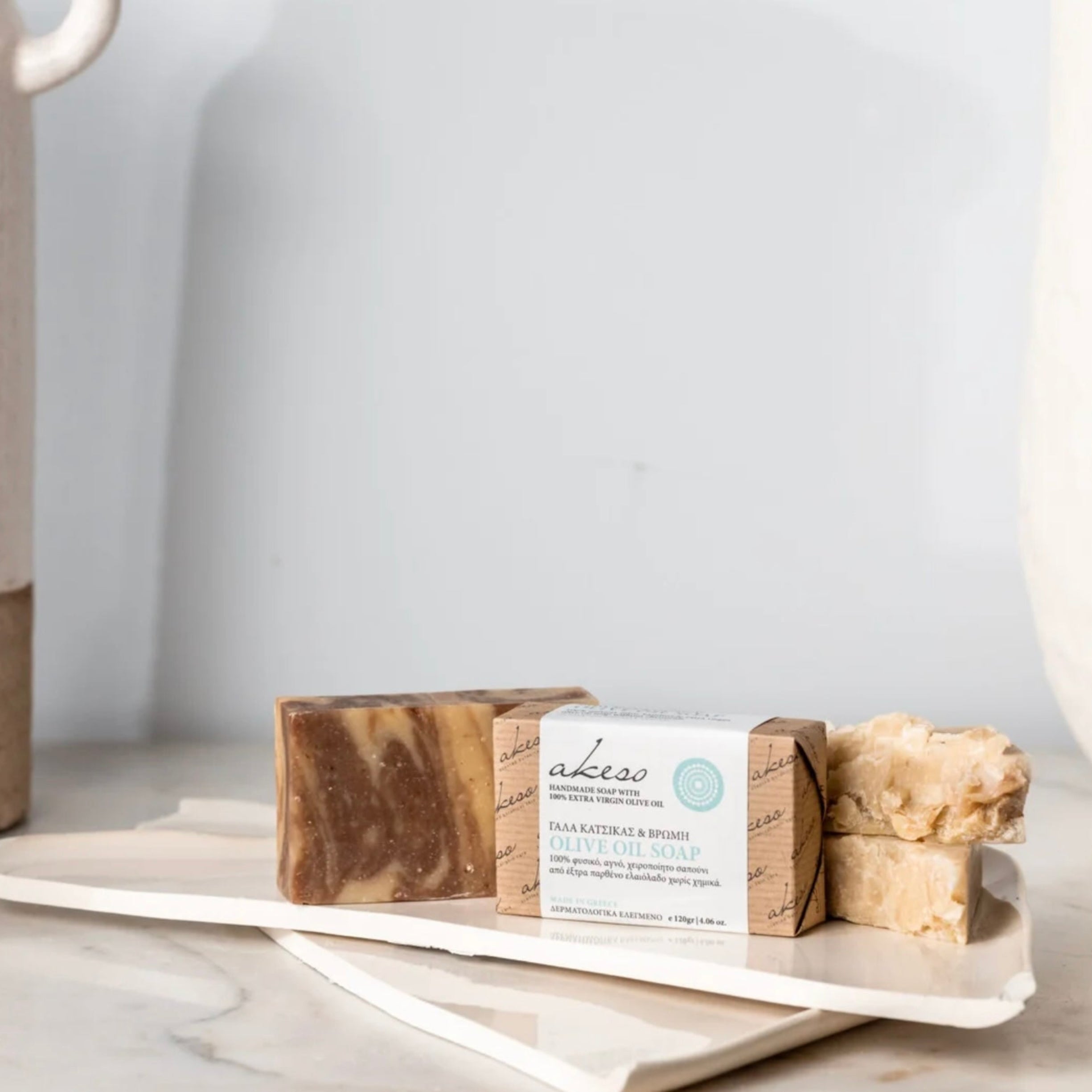 Greek Goat Milk and Oat Olive Oil Soap made with Laconic Foods extra virgin olive oil displayed with handmade soap bars in a Mediterranean-inspired setting