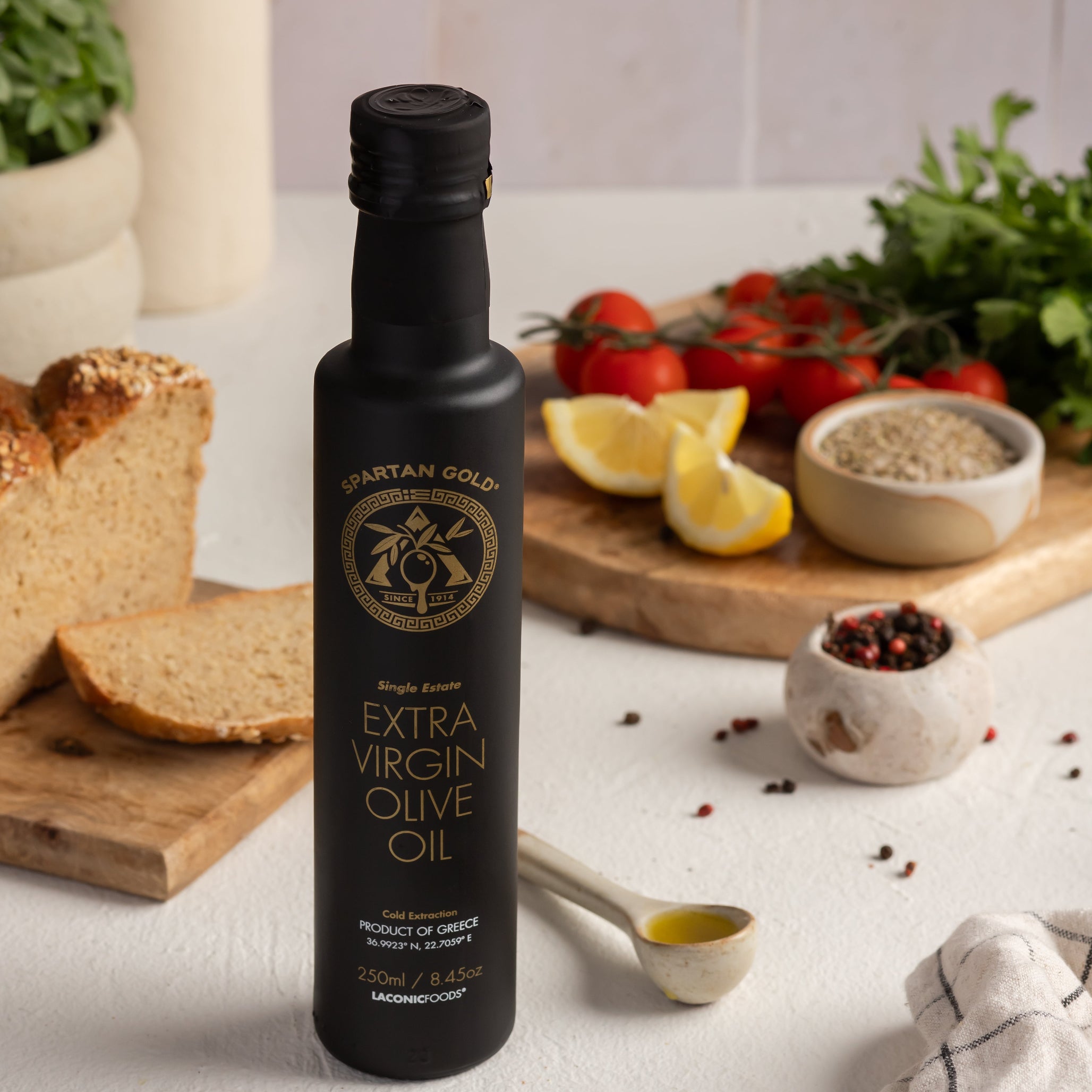 Laconic Foods Greek extra virgin olive oil with bread, herbs, and lemon – healthy Mediterranean setting