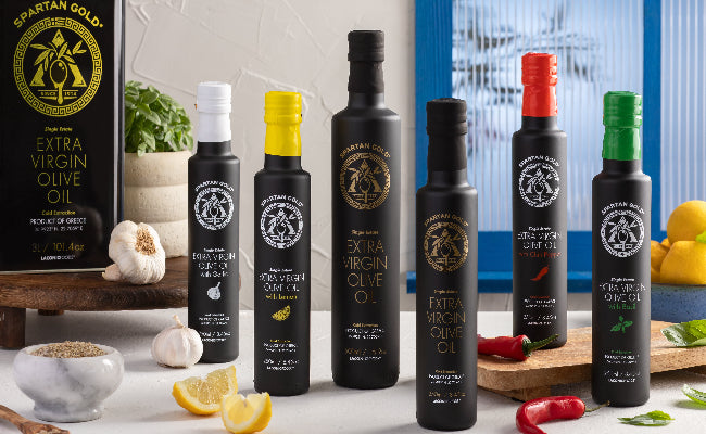 Award-winning Greek extra virgin olive oils by Laconic Foods, featuring garlic, lemon, chili, basil, and unflavored single estate EVOO in matte black bottles.