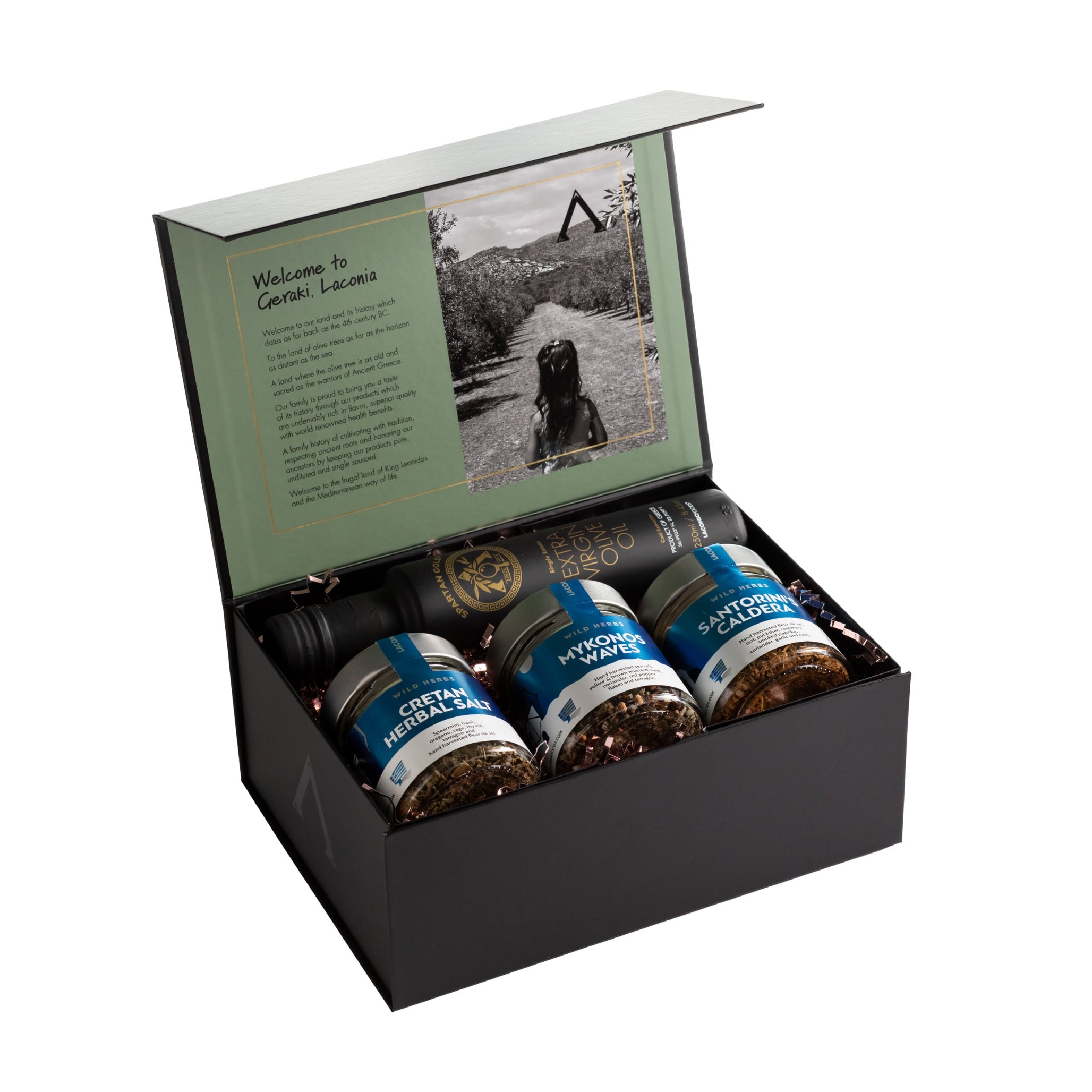Laconic Foods premium gift box with extra virgin olive oil and three Greek herbal spice blends, open to show story panel with olive groves and young daughter.