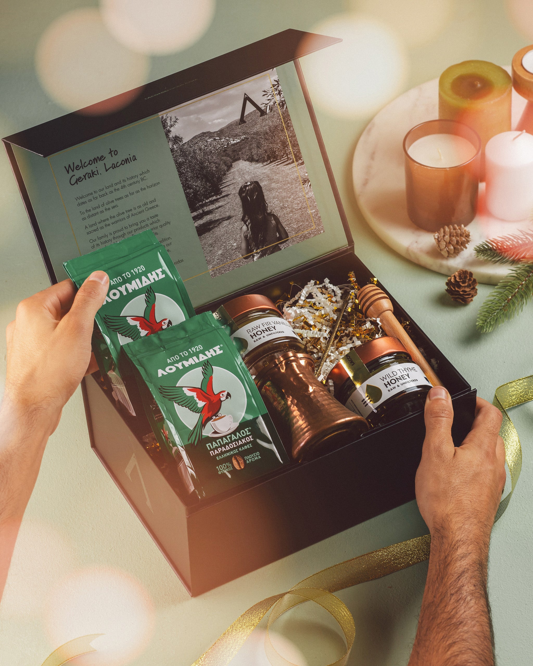 Festive Greek Coffee and Honey Gift Box with Loumidis coffee, raw honey jars, briki, and honey dipper, styled with candles and holiday ribbon.