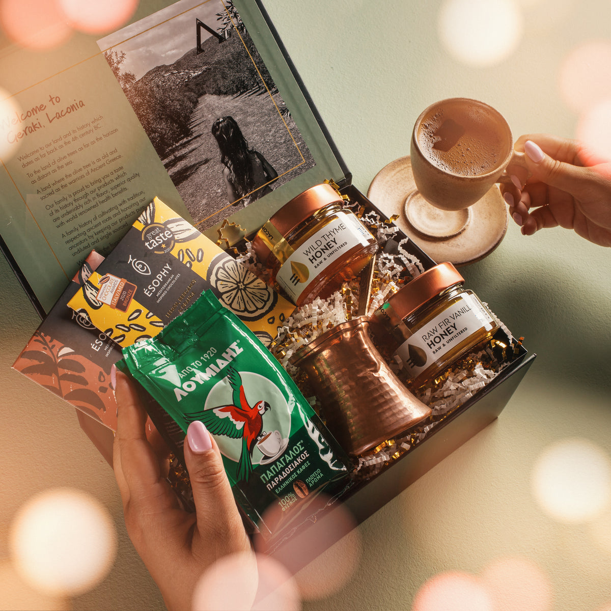 Laconic Foods Greek coffee and honey gift box with Loumidis coffee, Greek chocolates, copper briki, raw Greek honey, and a cup of coffee.