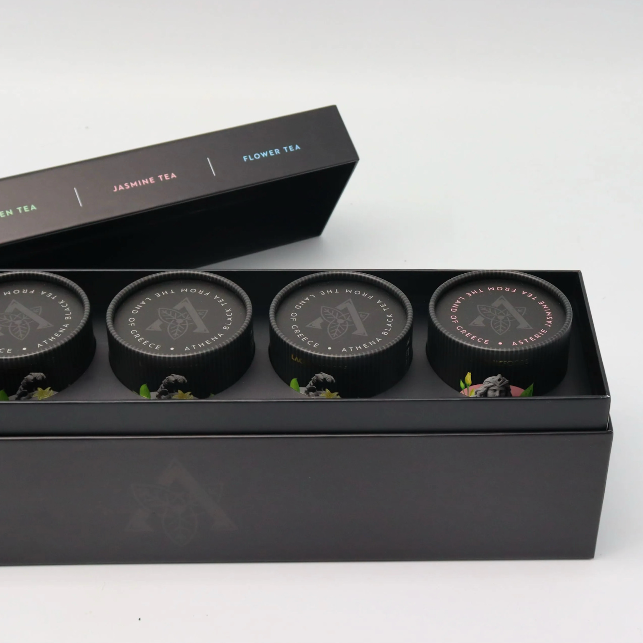 Laconic Foods Premium Greek Loose Leaf Tea Gift Set featuring five 75g paper tubes in an elegant matte black gift box.