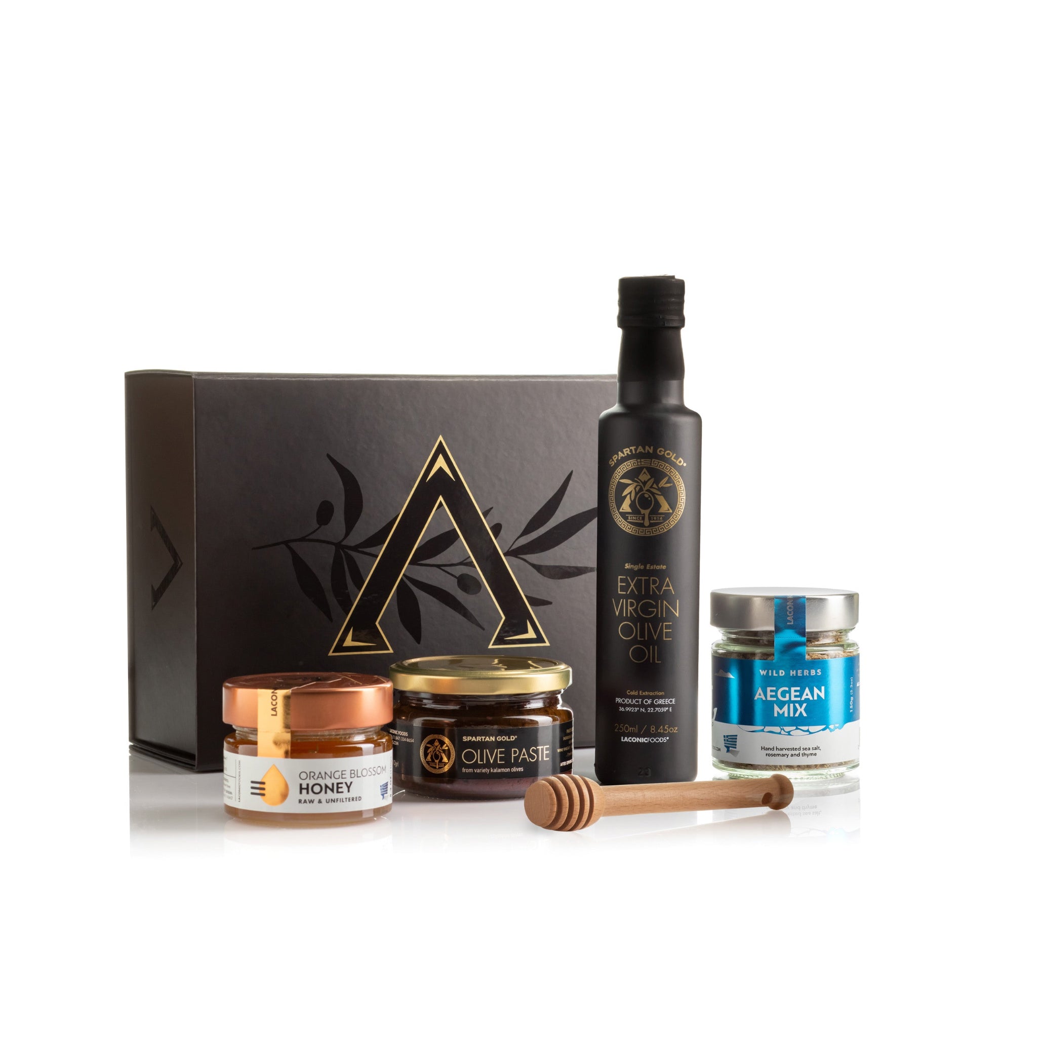 Laconic Foods premium Greek gift set with olive oil, honey, olive paste, and Aegean spice blend jars displayed beside gift box