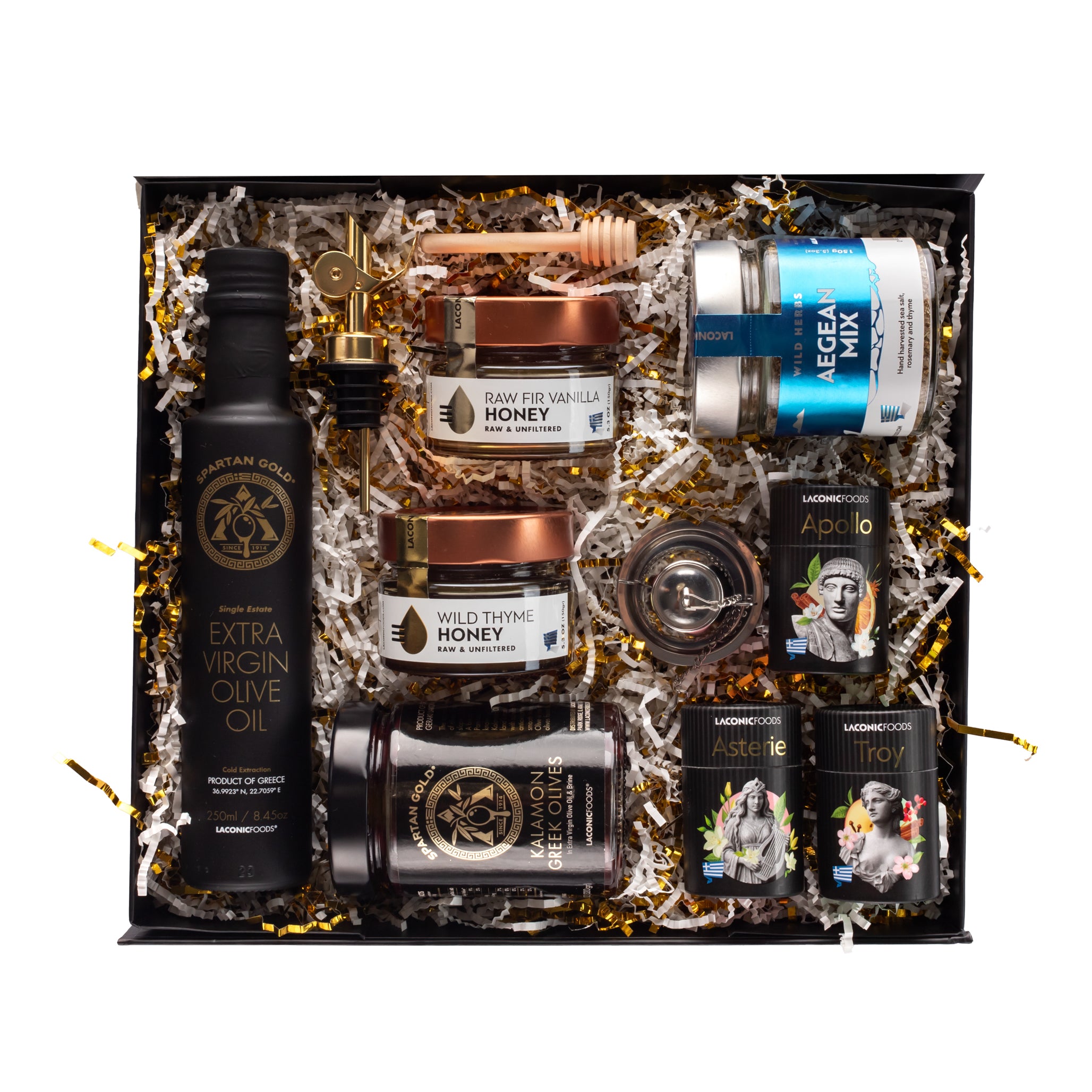 Top-down view of the Laconic Foods Premium Greek Gift Box featuring extra virgin olive oil, Kalamon olives, wild thyme honey, vanilla fir honey, Aegean spice mix, mini teas, tea infuser, and honey dipper.
