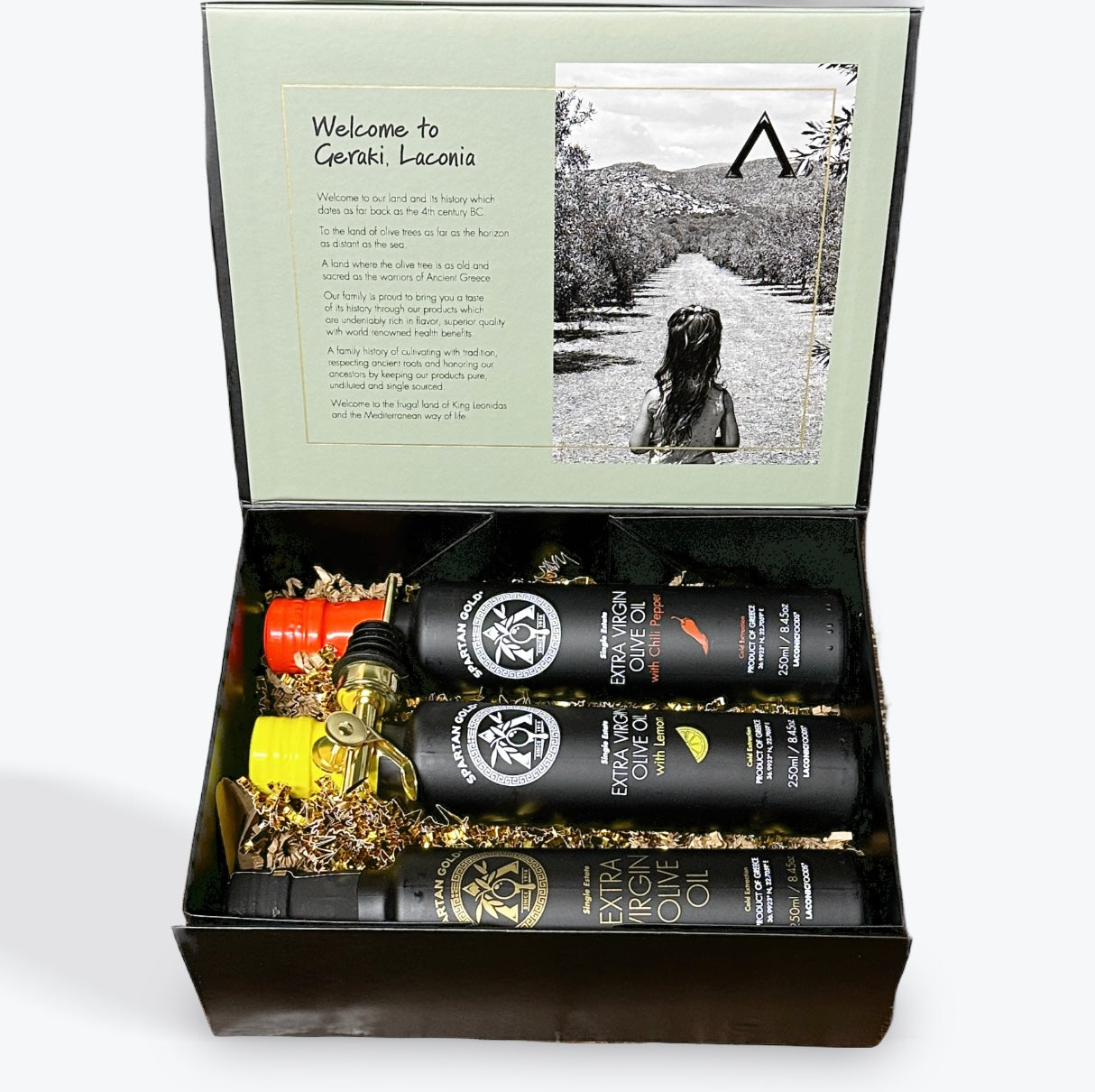 Laconic Foods Gift Box with Chili, Lemon, and Extra Virgin Olive Oil bottles in festive filler paper.