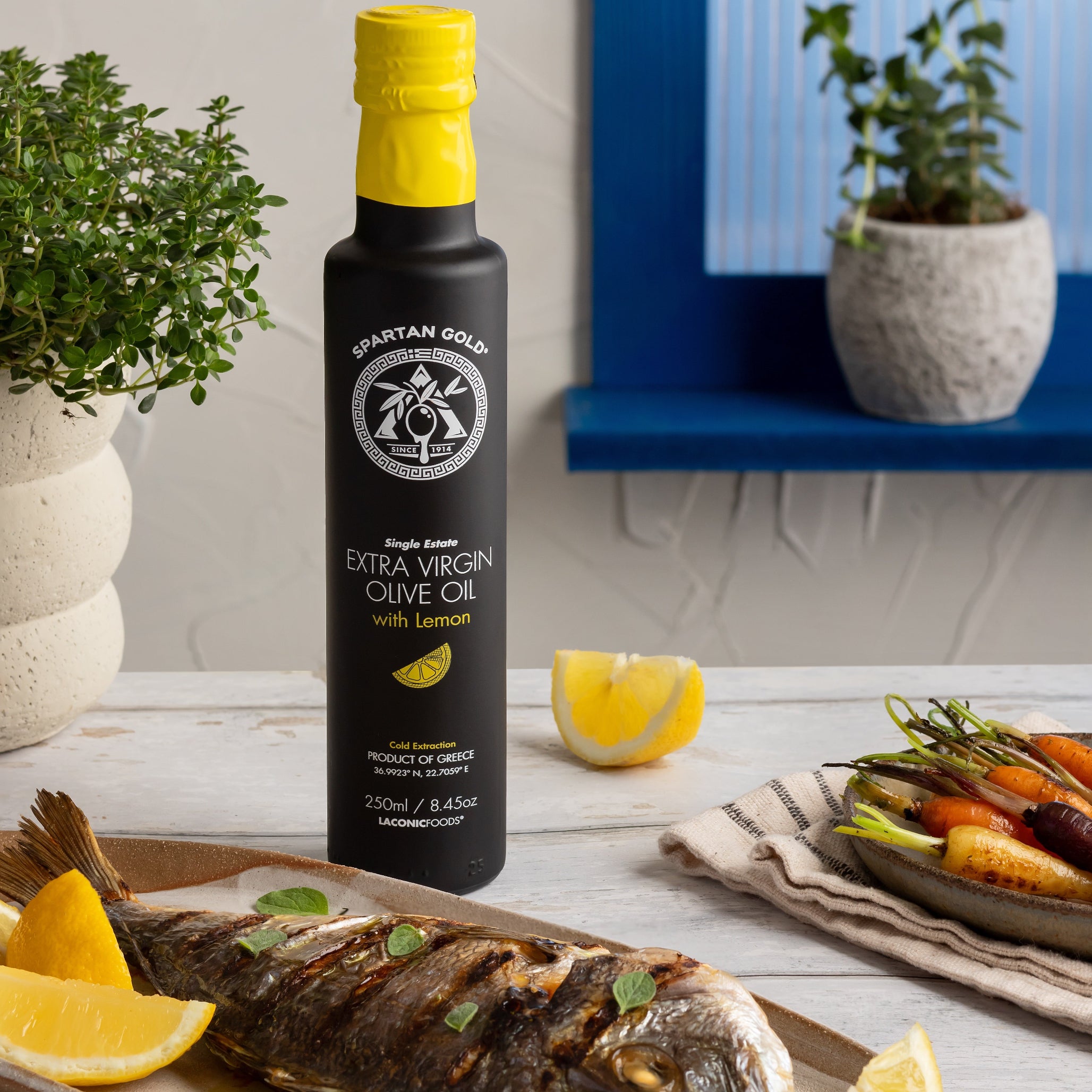 Lemon infused olive oil with grilled fish, lemon wedges, and vegetables in a Mediterranean kitchen setting