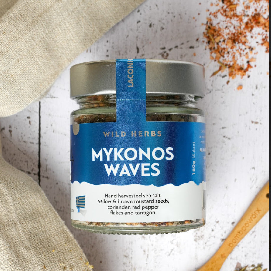Laconic Foods Mykonos Waves Spice Blend with wooden spoon and scattered herbs – Mediterranean seasoning mix