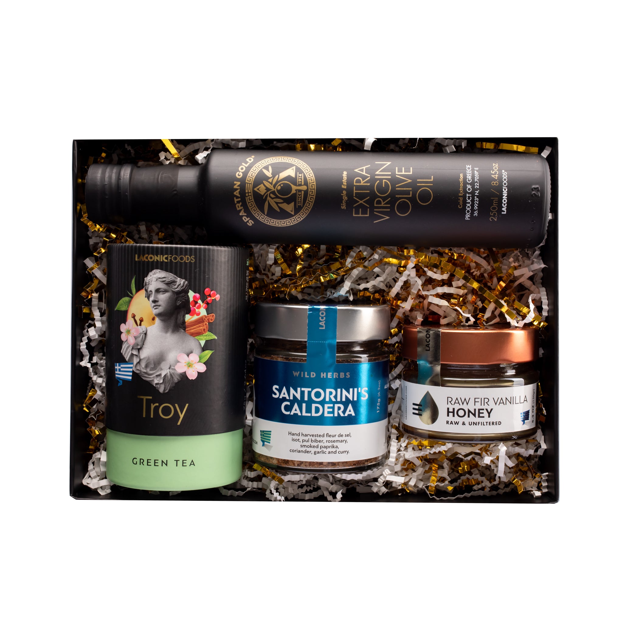 Top view of Laconic Foods premium Greek culinary gift box with extra virgin olive oil, loose leaf tea, raw Greek honey, and island spice blends in a luxury black box