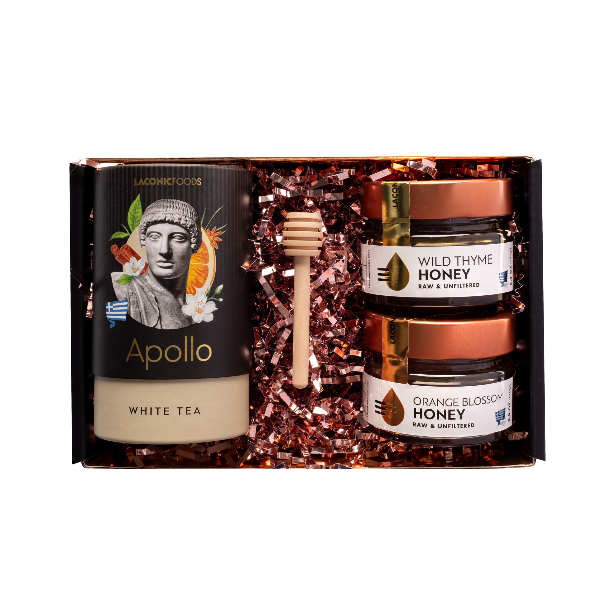 Top view of Laconic Foods Greek tea and honey gift box featuring Apollo white tea, two raw Greek honeys, and a wooden honey dipper in luxury packaging