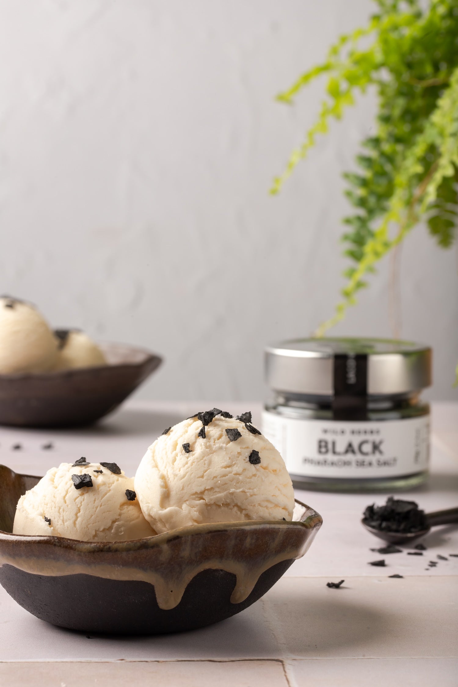 Black Pharaoh Sea Salt used as a topping on vanilla ice cream in a ceramic bowl
