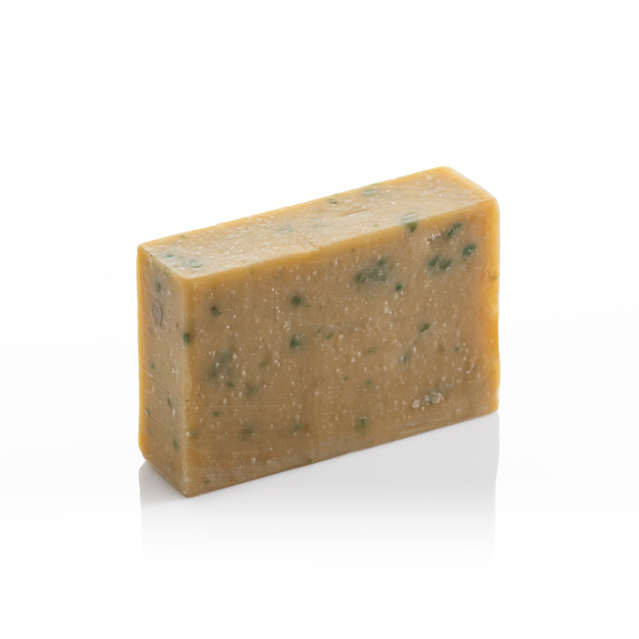 Unwrapped honeysuckle and silk olive oil soap bar with natural green botanical pieces on a clean white background.