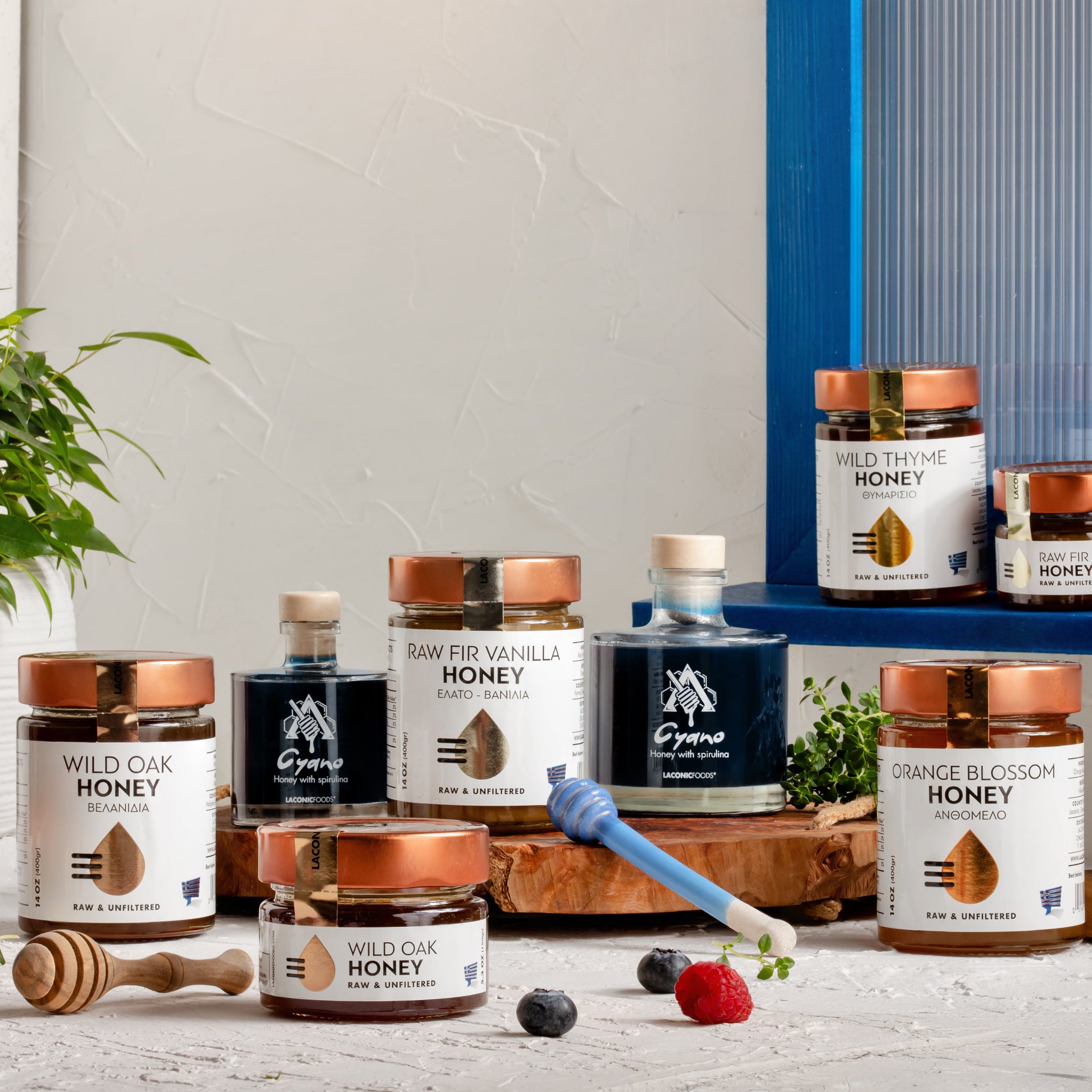 Laconic Foods Greek raw and unfiltered honey collection including Wild Thyme, Oak, Orange Blossom, and Vanilla Fir honeys with honey dippers