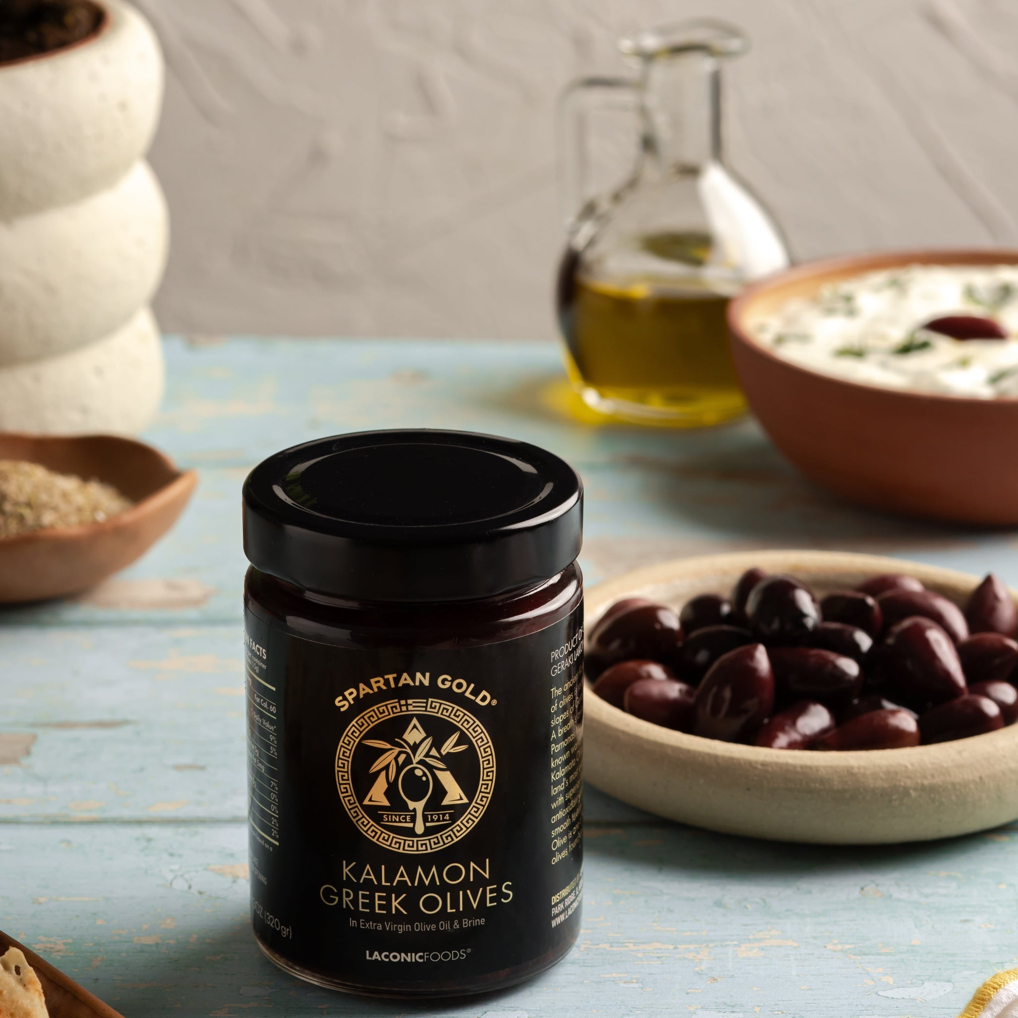 Laconic Foods Kalamon Olives served with pita and Mediterranean dishes