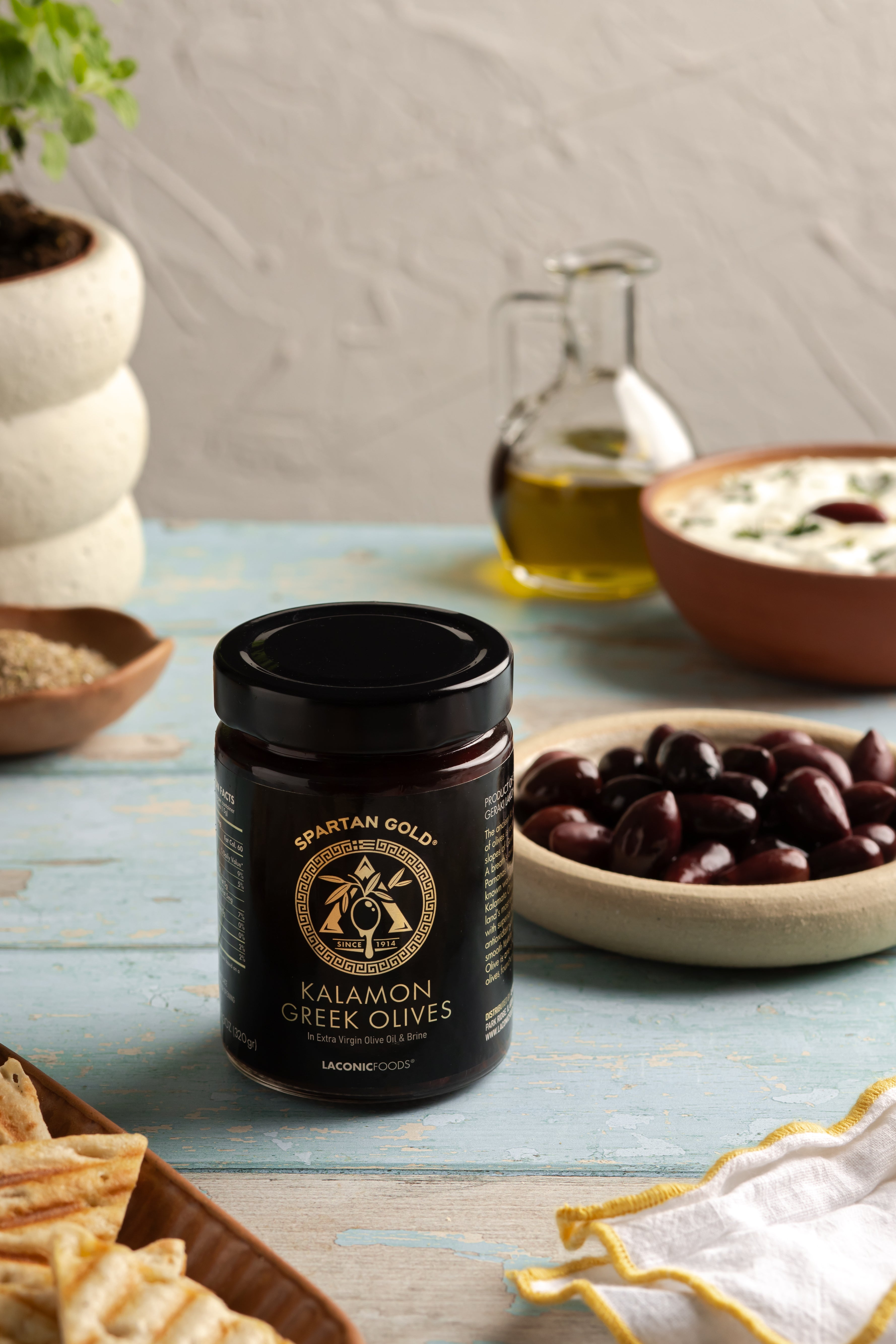 Laconic Foods Kalamon Olives served with pita and Mediterranean dishes