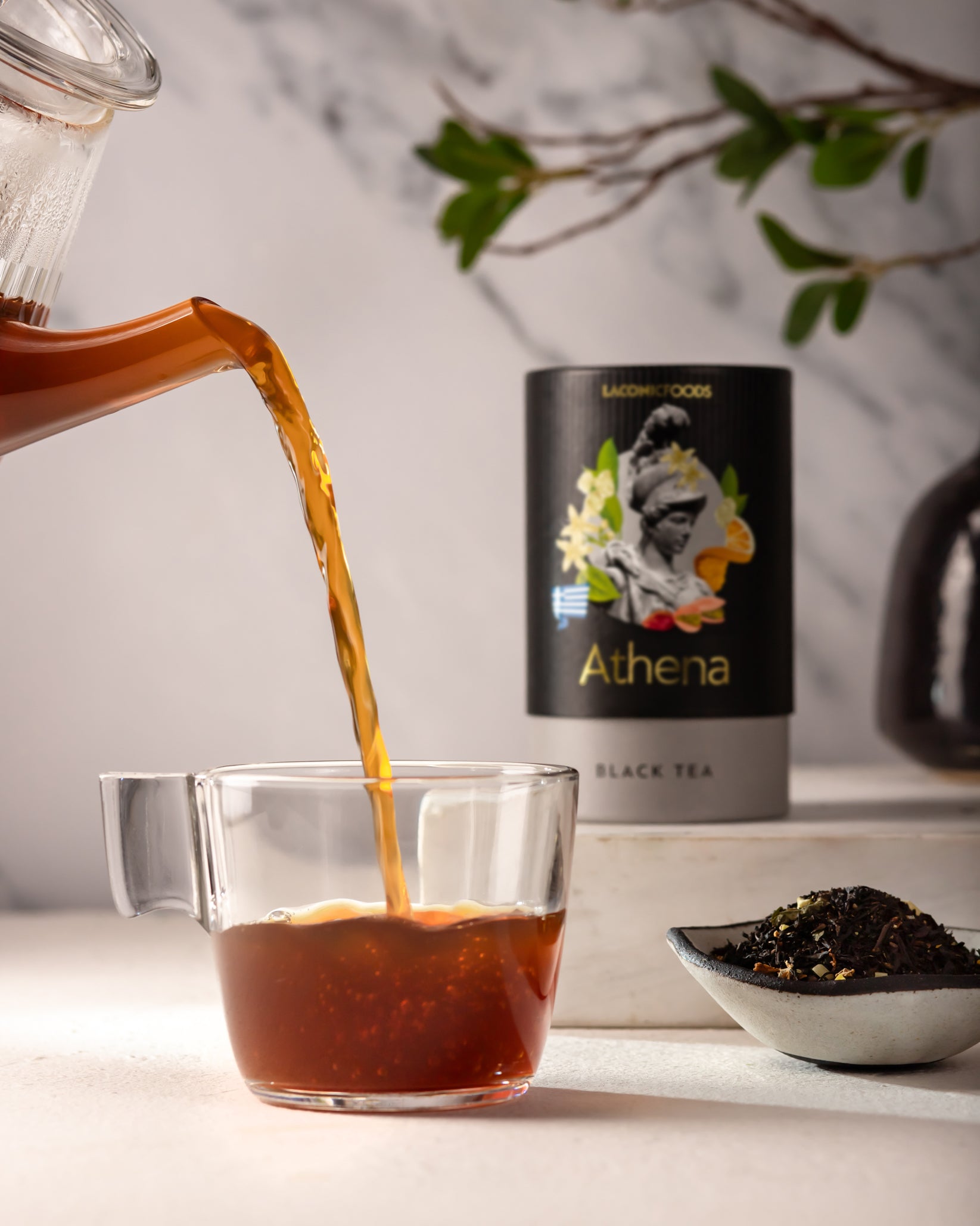 Laconic Foods Athena Black Tea poured into glass cup – rich amber infusion of premium Greek loose leaf black tea with citrus and floral notes.