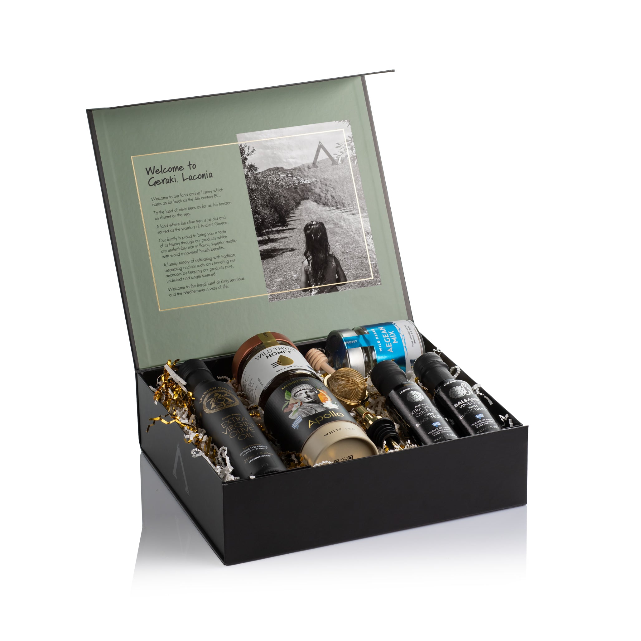 Laconic Foods Gourmet Experience Gift Box open to reveal Greek olive oils, truffle vinegar, wild thyme honey, Aegean spice mix, and Apollo tea in a luxury black box.
