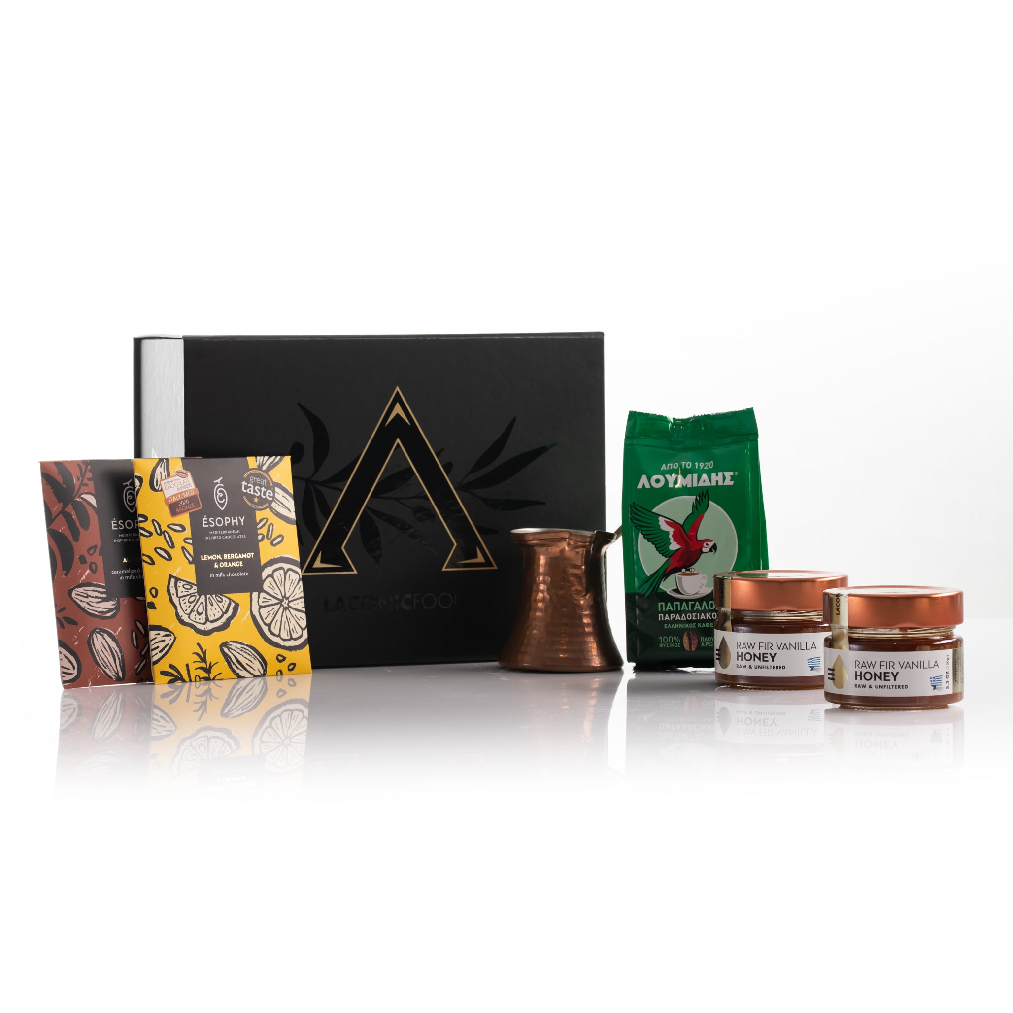 Laconic Foods Greek coffee, raw honey, and handmade chocolate gift set displayed with premium black gift box and accessories
