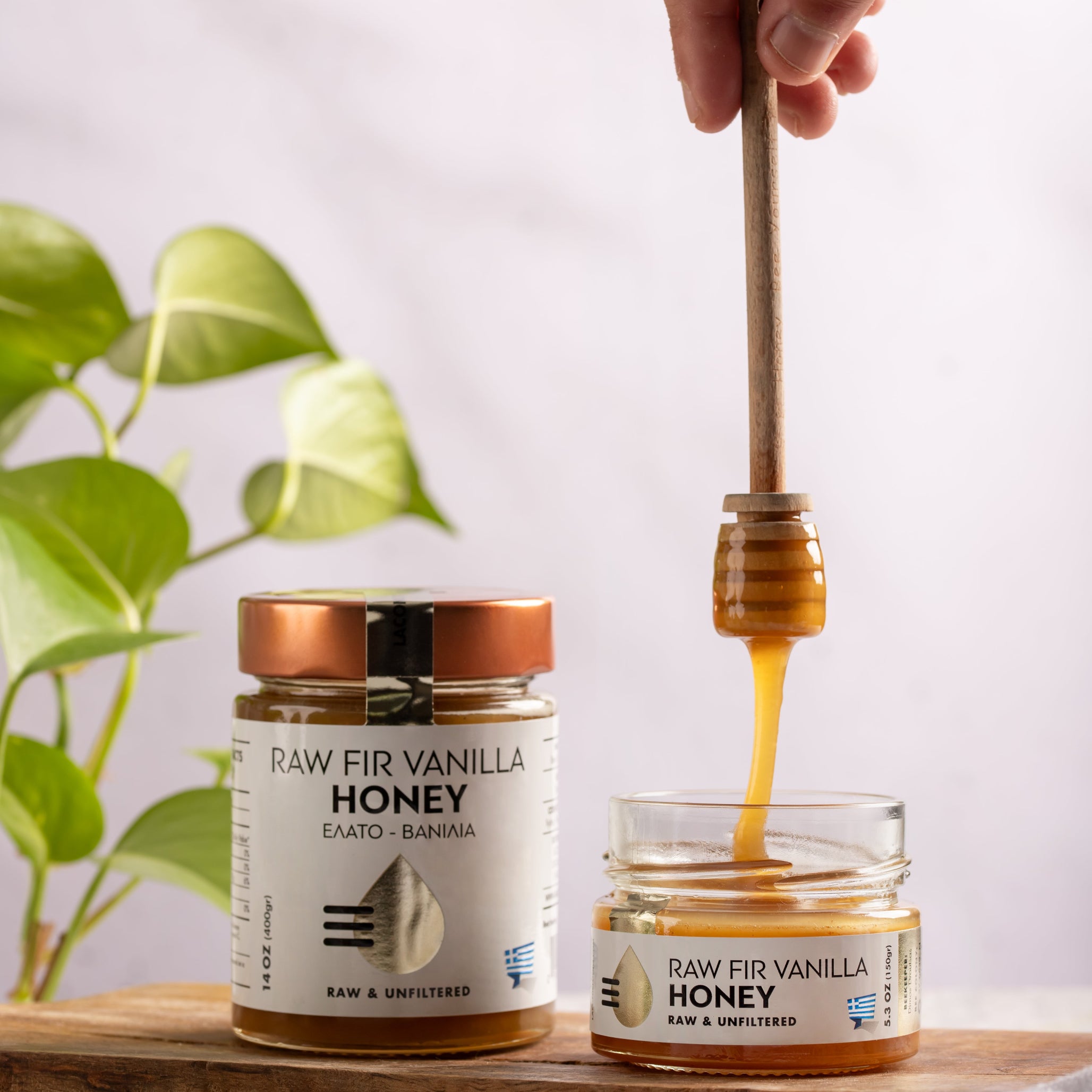 Laconic Vanilla Fir Honey being poured from dipper, with 150g and 400g jars