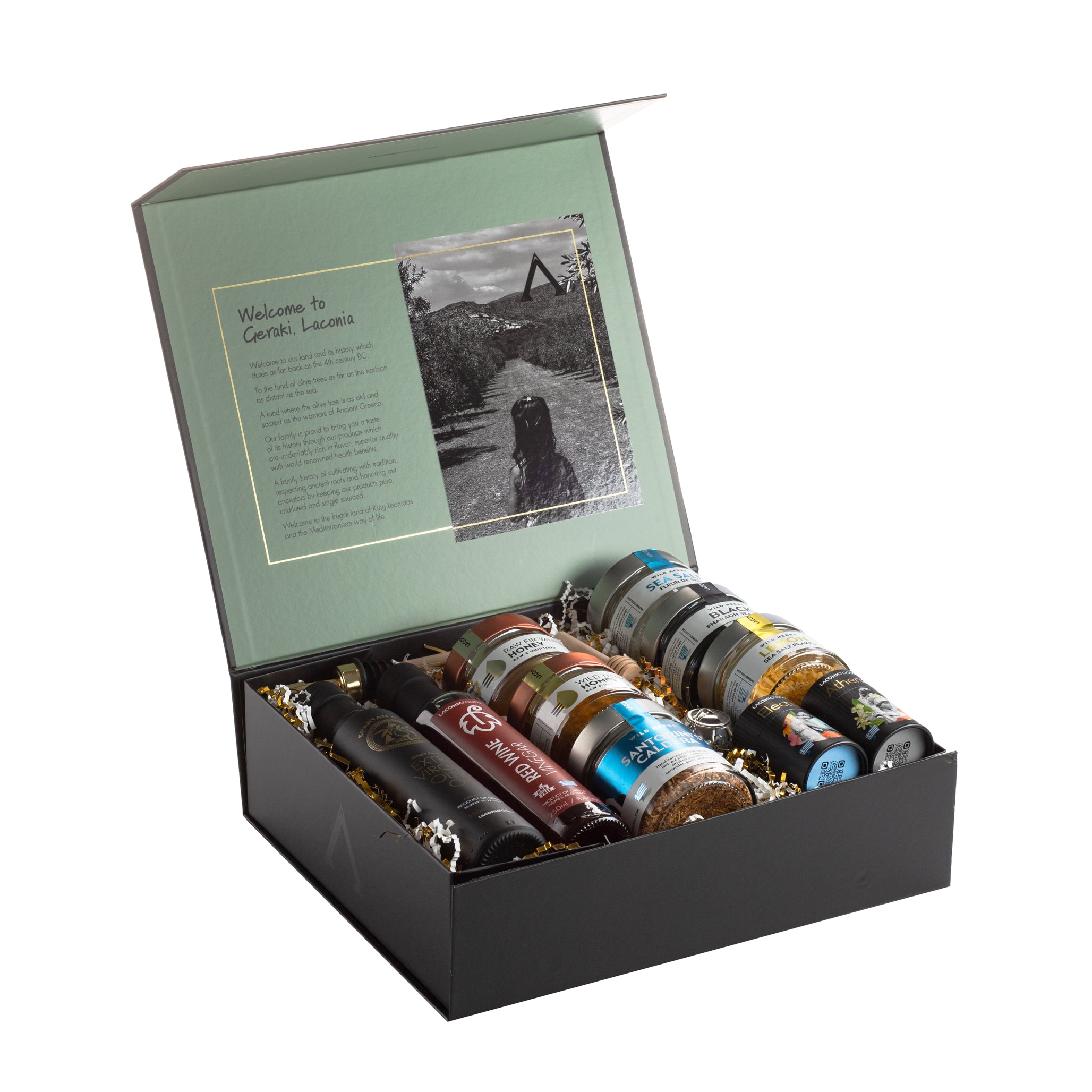 Open Laconic Foods gift box showing the interior welcome message from Geraki, Laconia, with all gourmet Greek products neatly arranged inside.