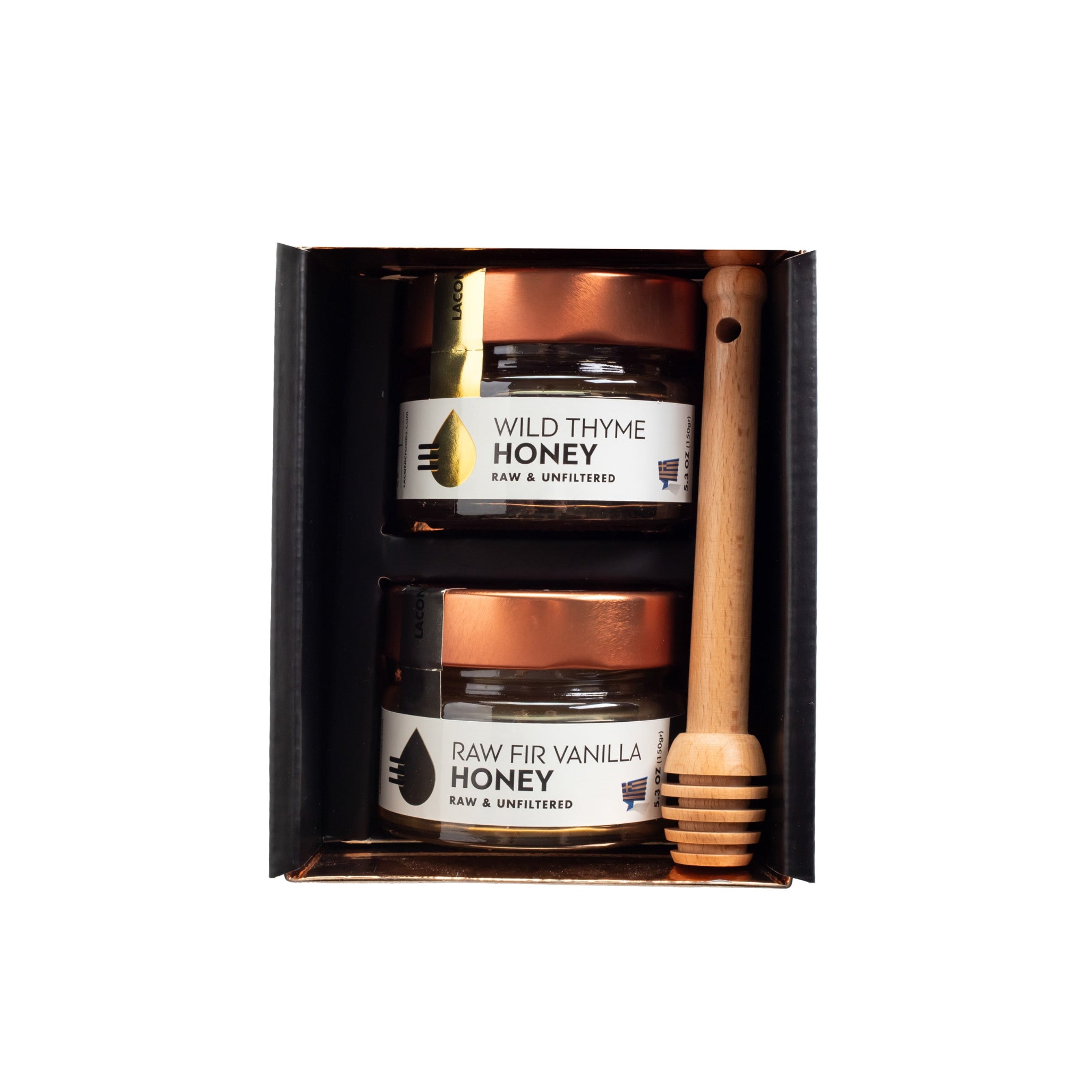 Close-up of Laconic Foods Wild Thyme Honey and Raw Fir Vanilla Honey jars in gift box with dipper.