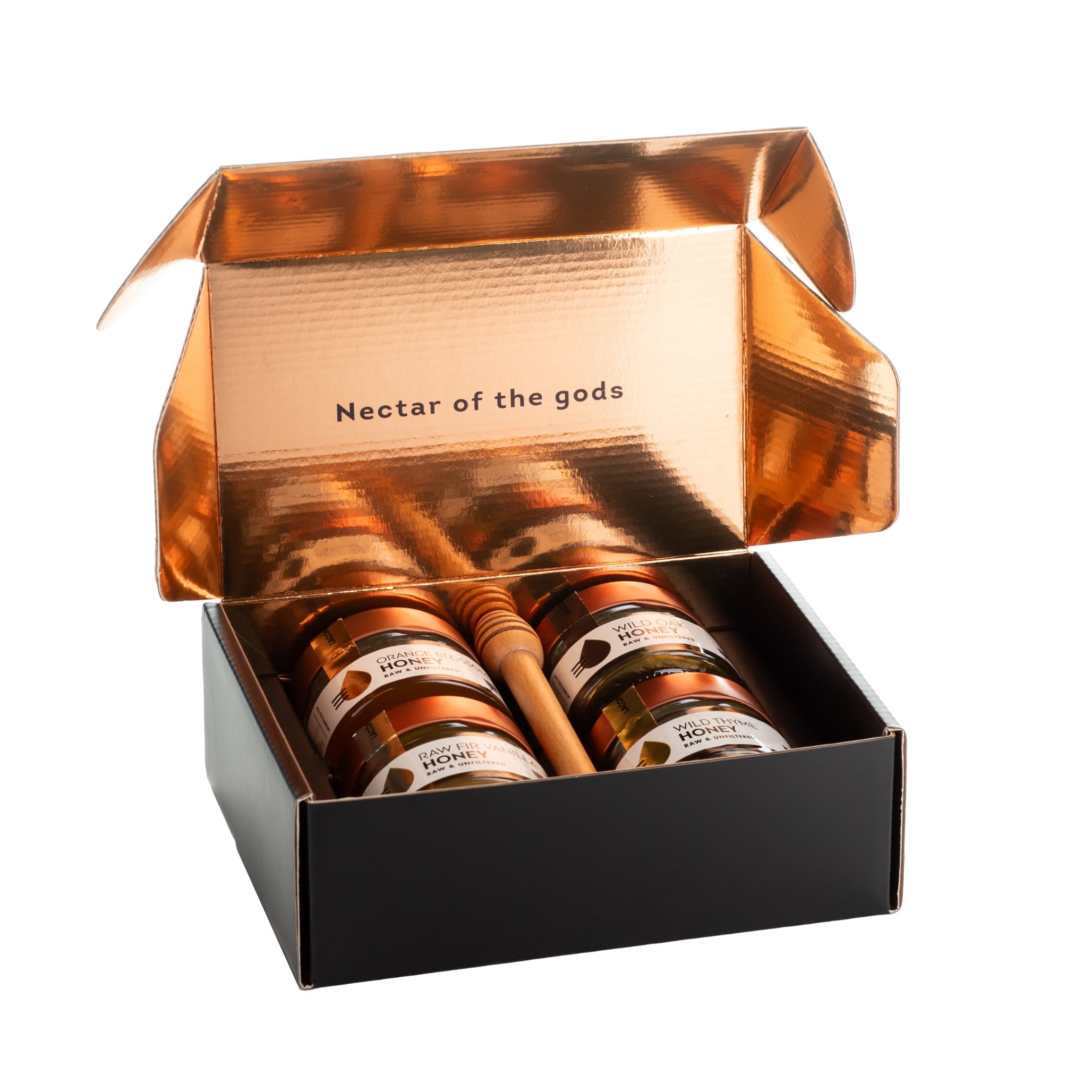 Open Laconic Foods honey gift box with copper interior reading Nectar of the Gods, featuring four Greek honey varieties and dipper.