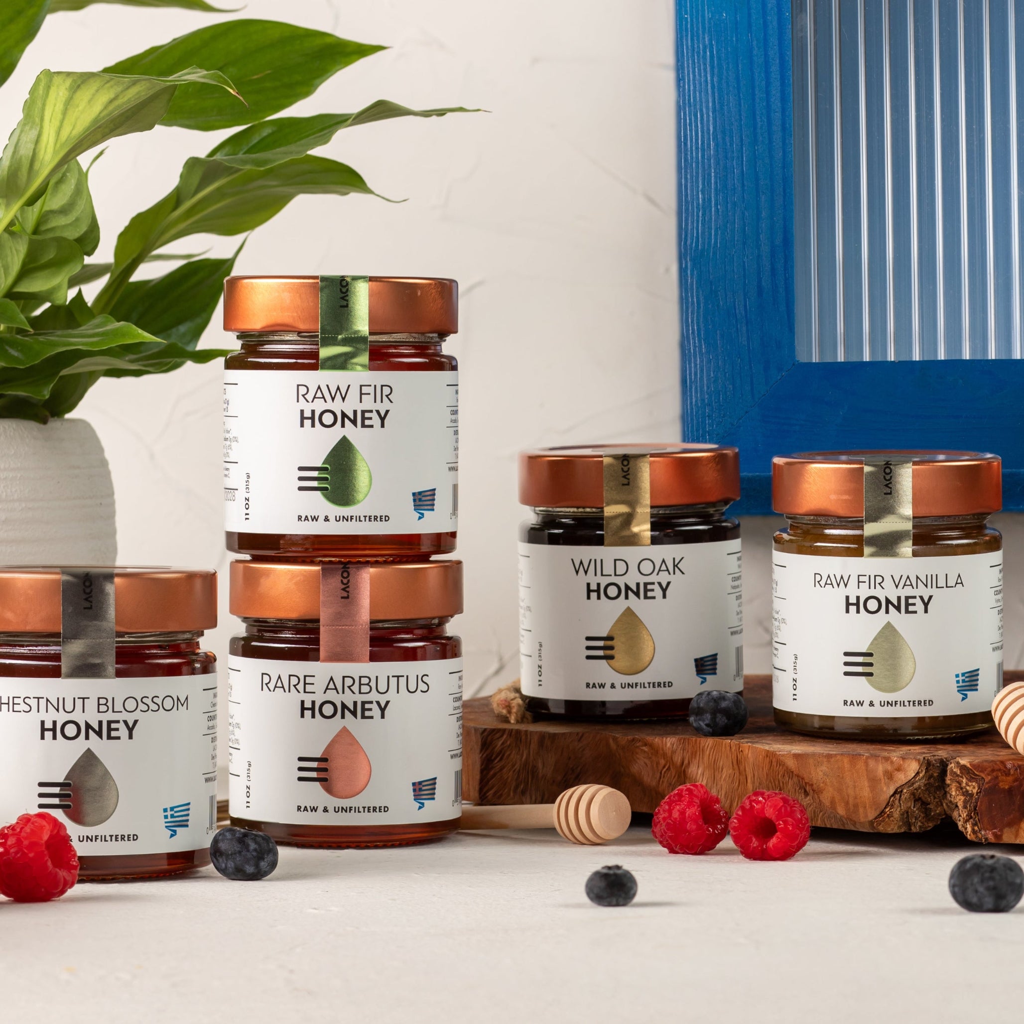 Selection of Greek raw honey jars by Laconic Foods, including chestnut blossom, fir, wild oak, arbutus, and vanilla fir honey.
