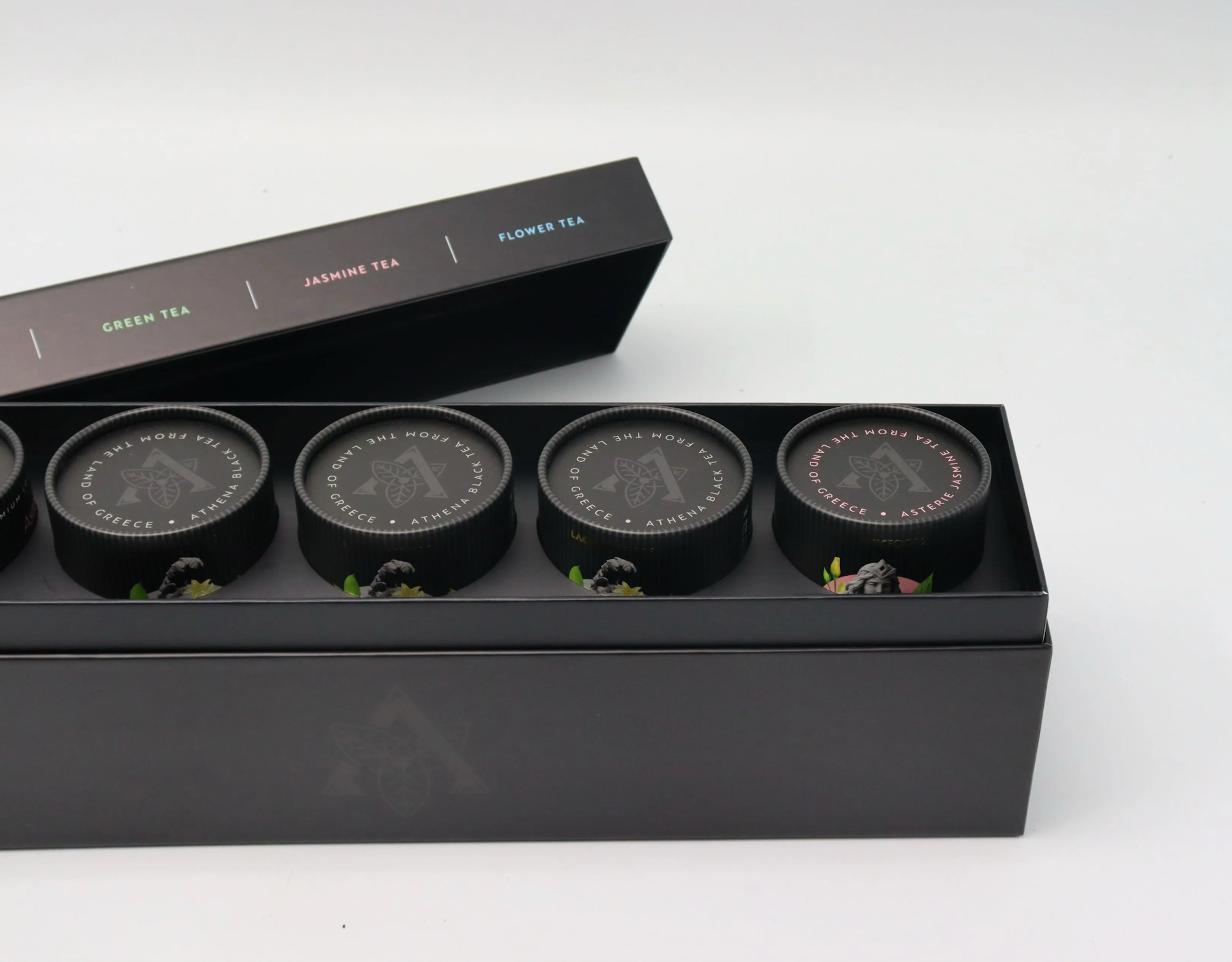 Laconic Foods Premium Greek Loose Leaf Tea Gift Set featuring five 75g paper tubes in an elegant matte black gift box.