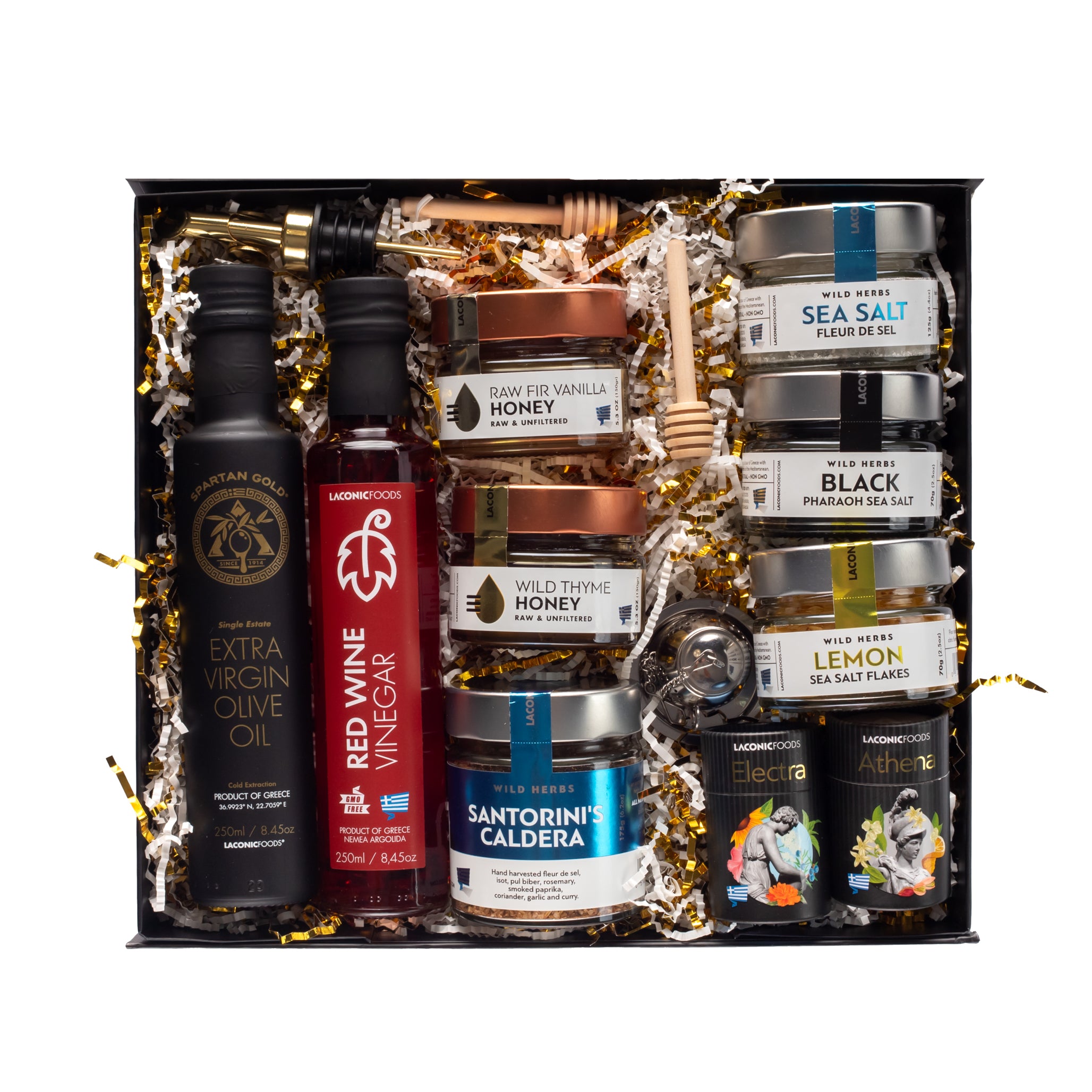 Top-down view of the Laconic Foods Luxury Greek Gift Box featuring extra virgin olive oil, red wine vinegar, raw Greek honeys, premium Greek sea salts, Santorini spice blend, mini teas, honey dippers, and tea infuser arranged in a black premium gift box.