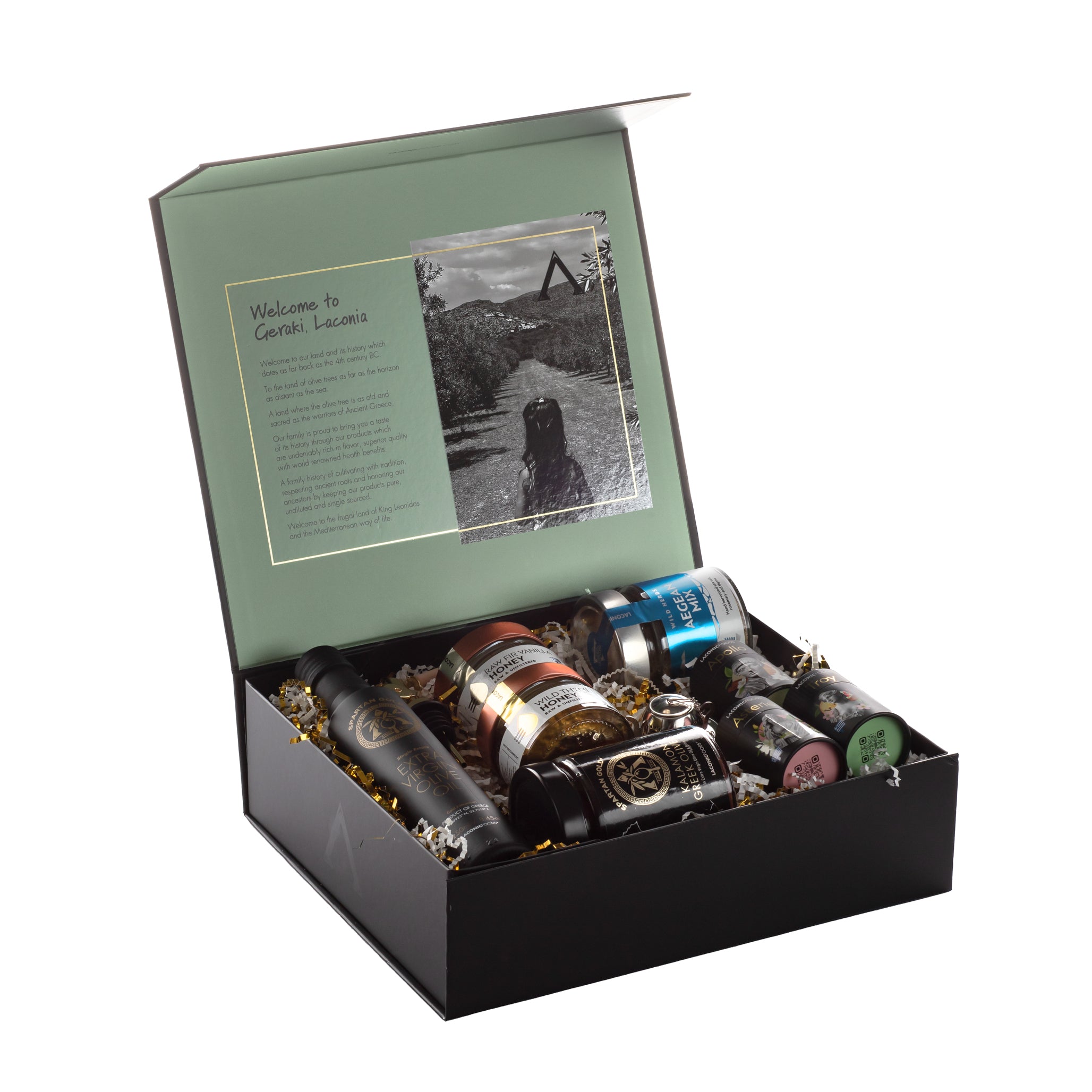 Open Laconic Foods Premium Greek Gift Box showing interior welcome message from Geraki, Laconia with Greek gourmet products arranged neatly inside.