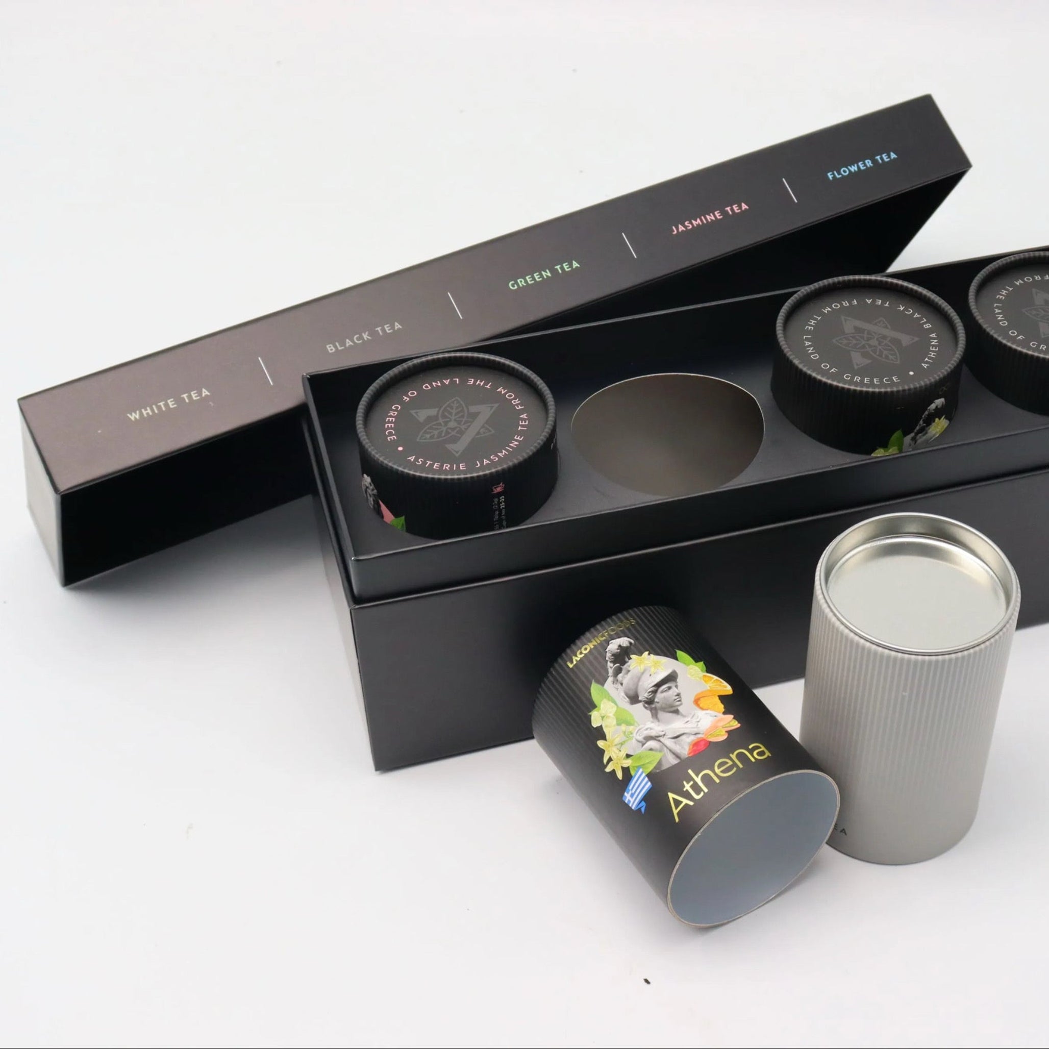 Athena black tea tube from Laconic Foods displayed in front of the Premium Greek Loose Leaf Tea Gift Set box.
