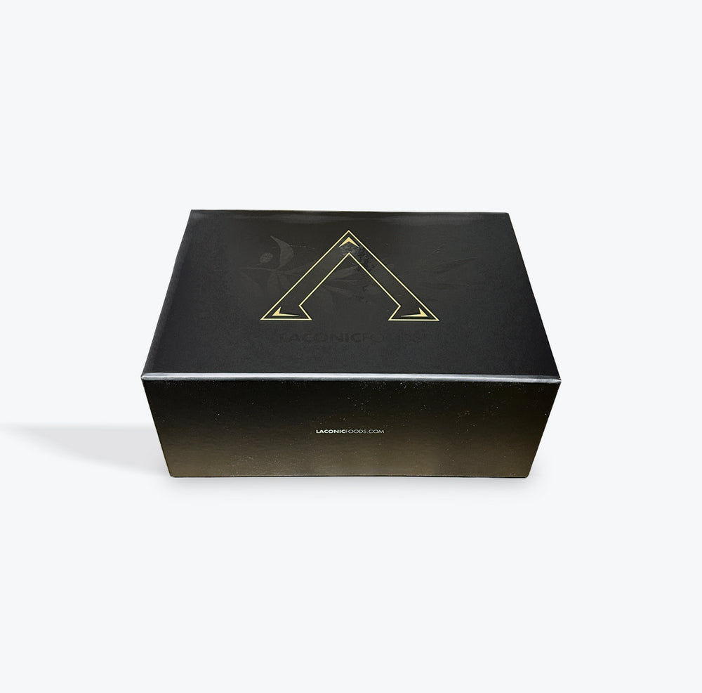 Premium Laconic Foods gift box in matte black with gold logo — top view of closed packaging
