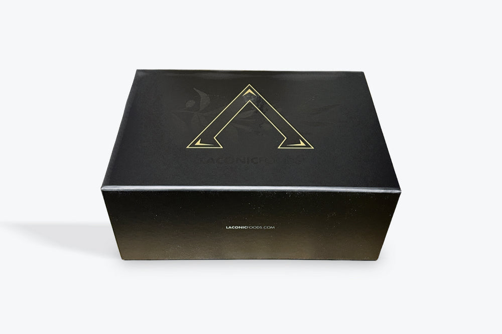 Laconic Foods premium gift box with gold Spartan-style emblem on matte black packaging