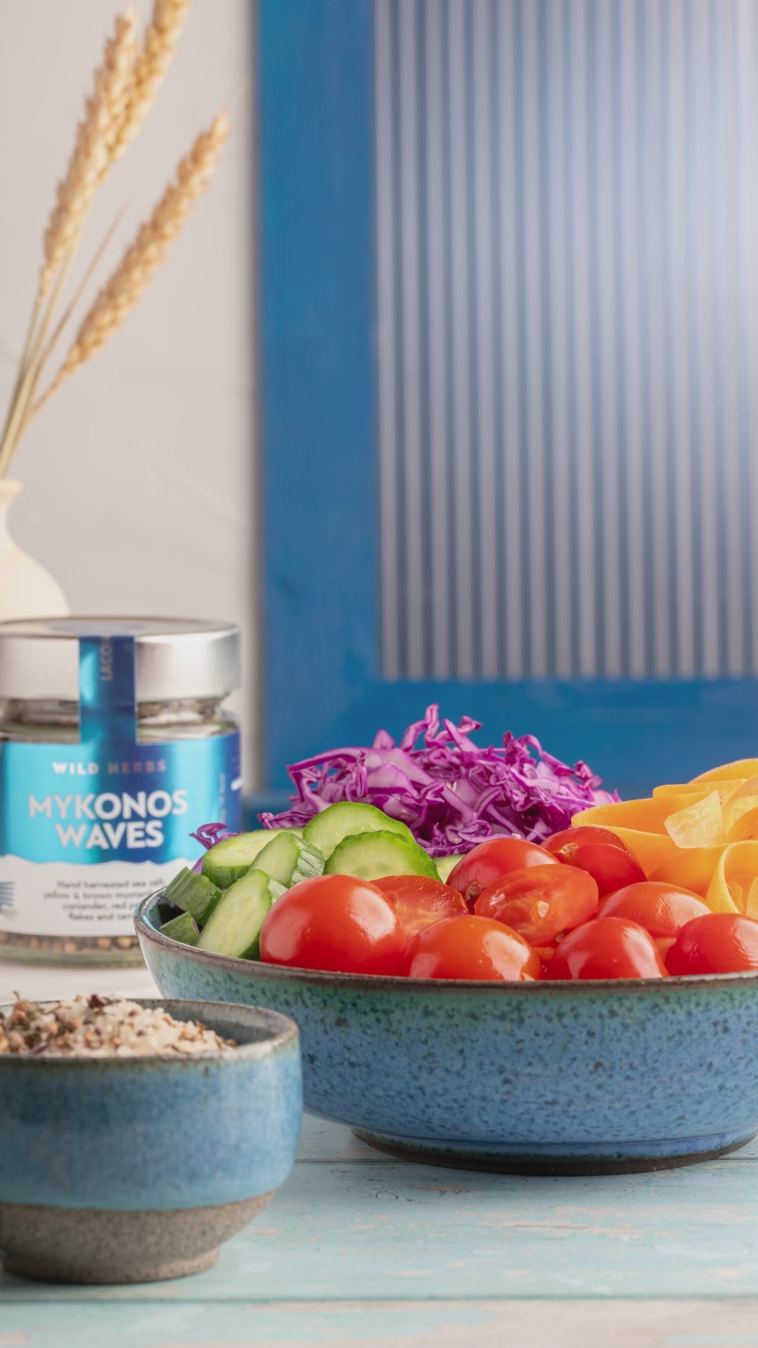 Video of Laconic Foods Mykonos Waves Spice Blend sprinkled over a fresh Greek salad with cherry tomatoes, cucumbers and red onions