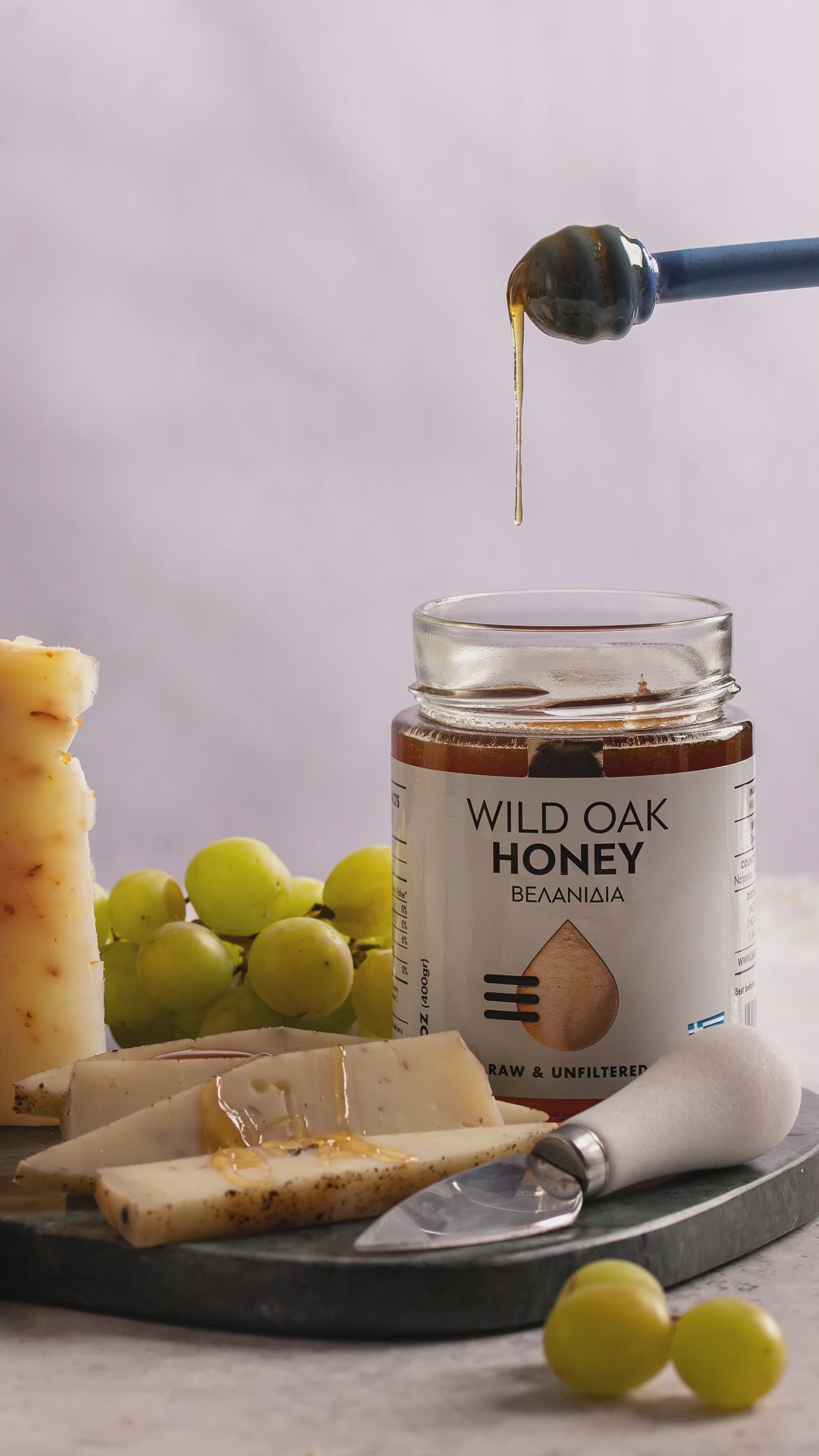 Video of Laconic Foods Greek wild oak honey being drizzled over artisanal cheese.