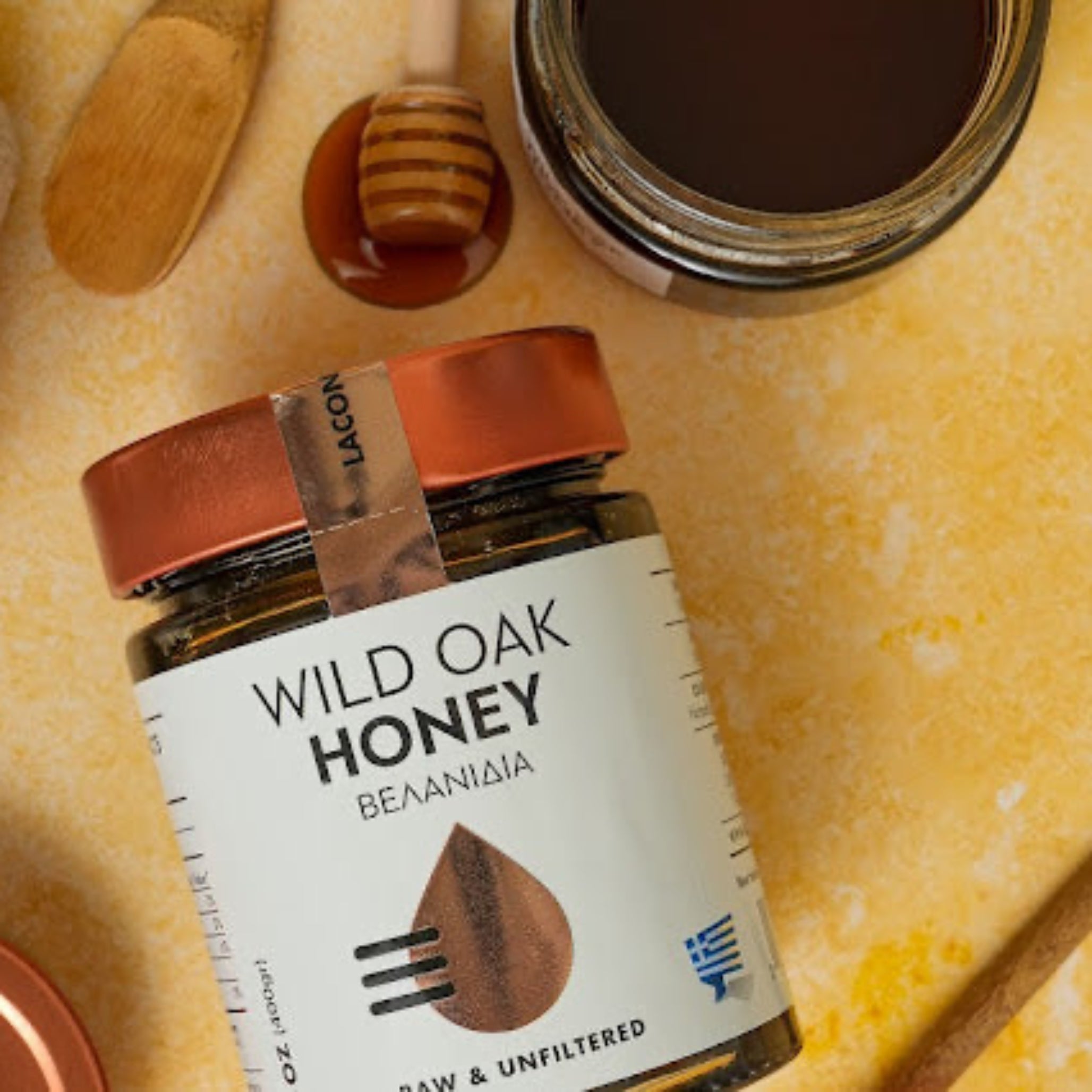 Top view of Wild Oak Honey jar with dipper on warm rustic background